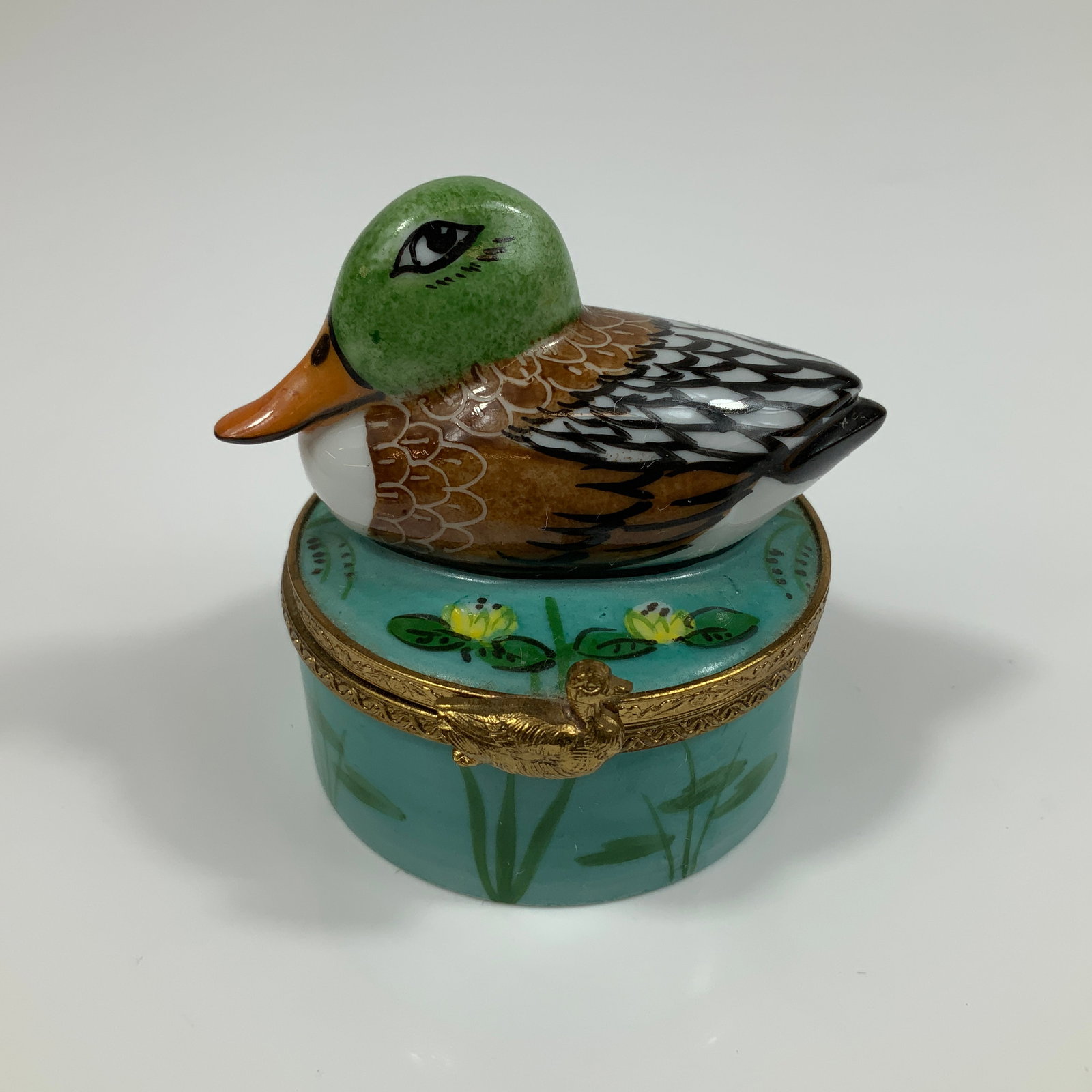 Limoges Hand Painted Porcelain Trinket Box, Mallard Duck: This genuine Limoges porcelain trinket box features a figural mallard duck lid and hand-painted decoration. The circular box is crafted from fine white porcelain and fitted with gold-toned metal mount
