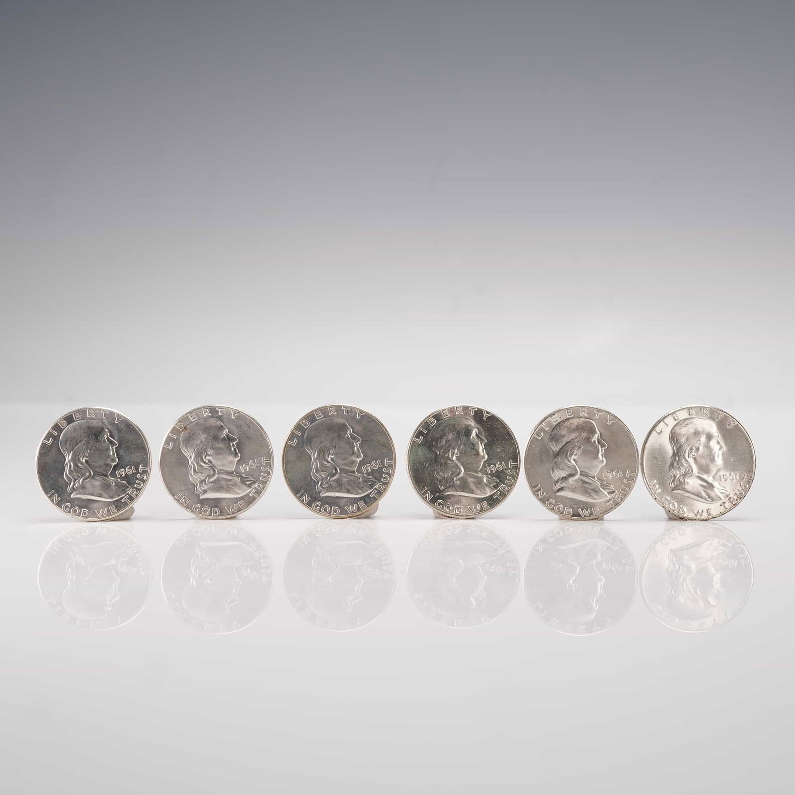 6pc 1961 Franklin Half Dollar Coins: Each coin struck in 90 percent silver with a total weight of 12.5 grams per coin. The obverse features a left-facing portrait of Benjamin Franklin with the inscriptions LIBERTY and IN GOD WE TRUST, wh