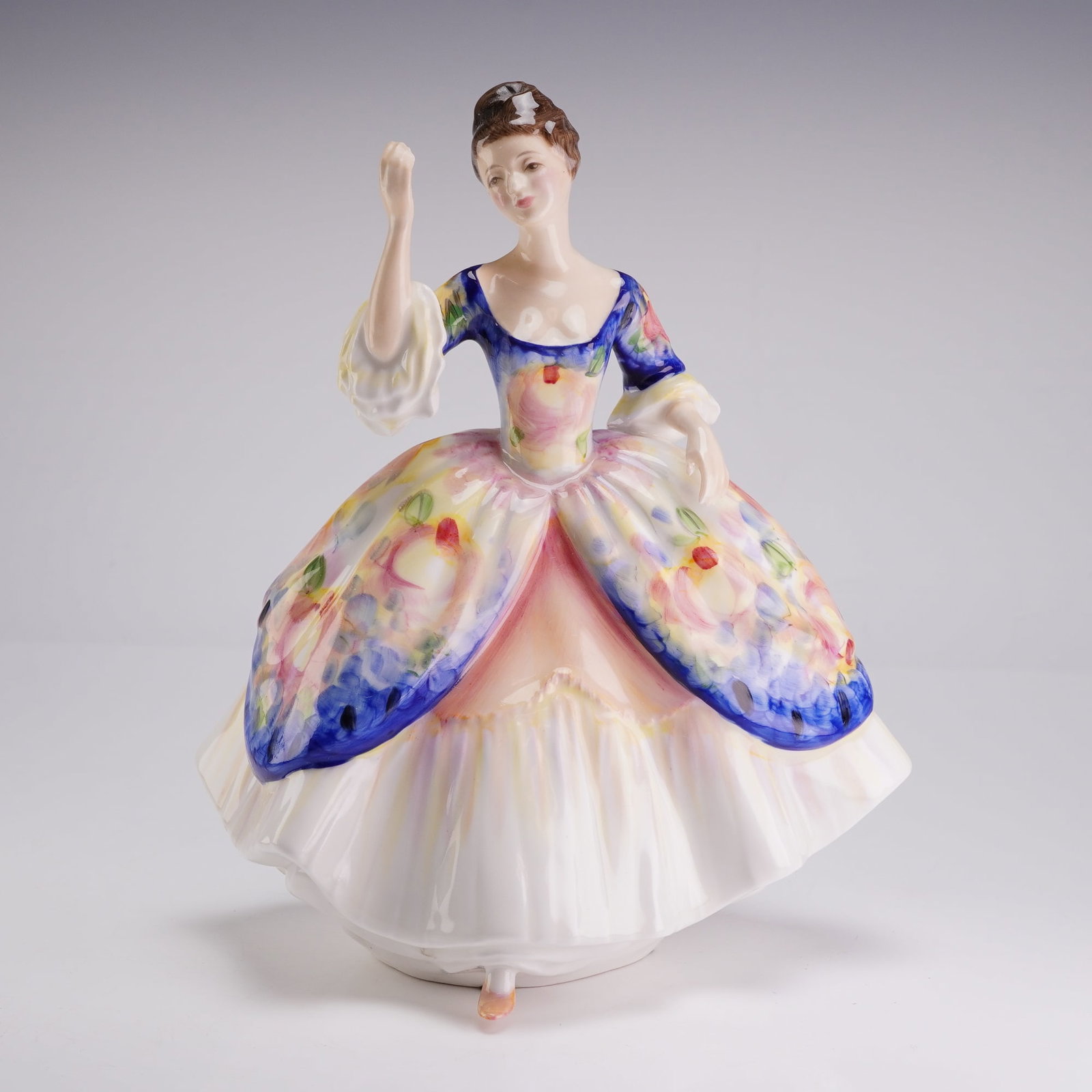 Royal Doulton Figurine Christine HN2792: A Royal Doulton fine bone china figurine titled Christine, model number HN 2792, designed by Peggy Davies. The hand-painted figure depicts a woman in 18th-century style dress. She is modeled with a de