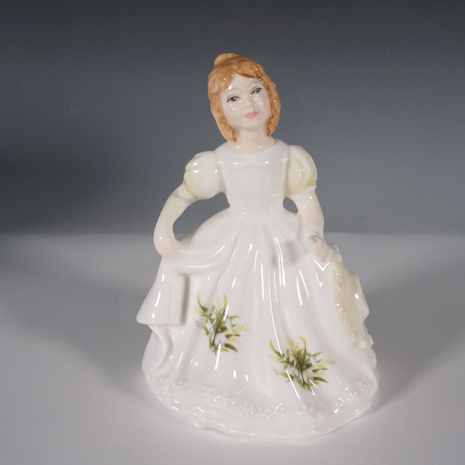 Royal Doulton, Figure of the Month, January, HN3330: This charming Royal Doulton figurine, titled Figure of the Month, January (HN 3330), was introduced in 1991 as part of the beloved Figure of the Month series. Expertly modeled by Robert Tabbenor, the 