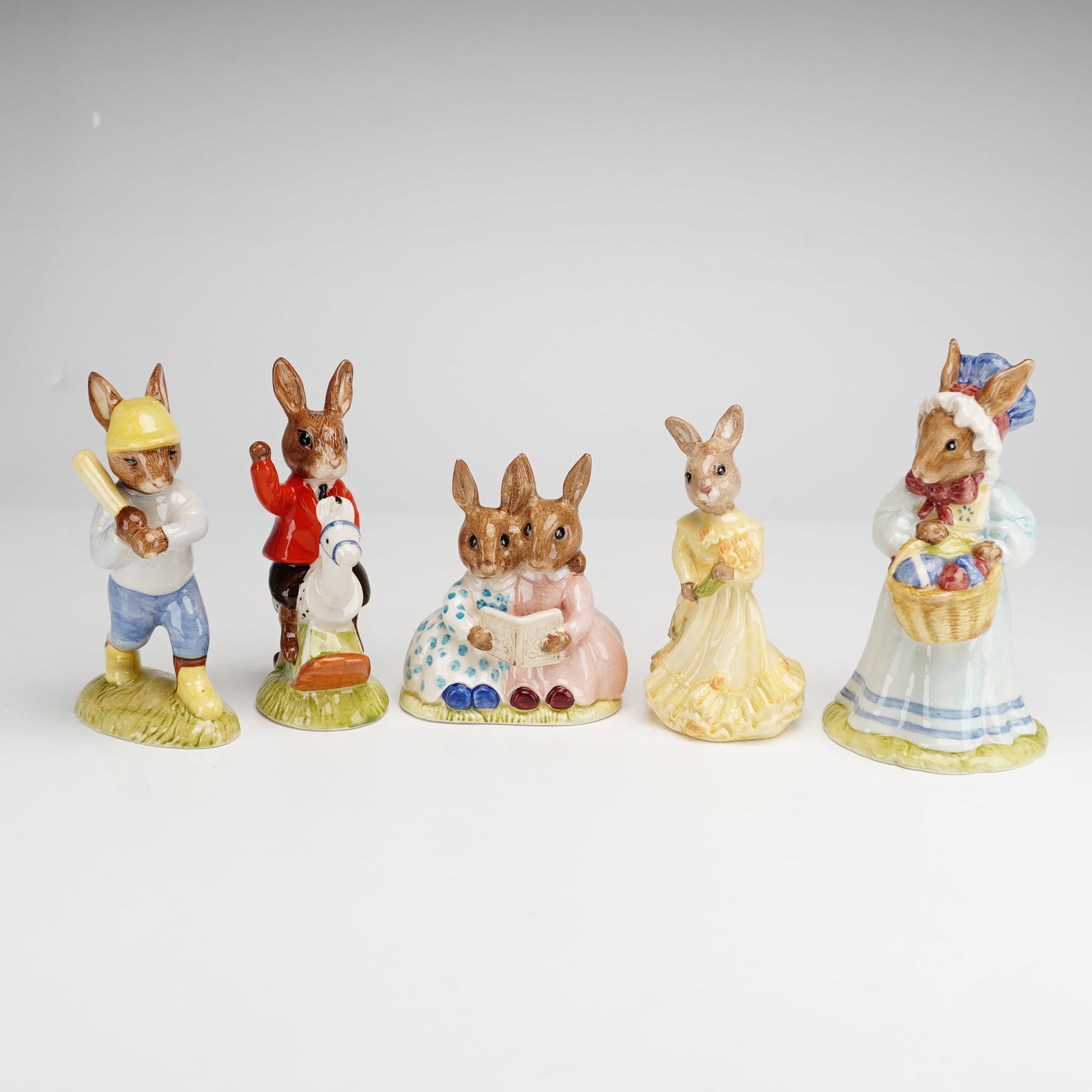 5pc Royal Doulton Bunnykins Figurines: A collection of five Royal Doulton Bunnykins figurines crafted from hand-painted glazed earthenware. This set includes characters in various anthropomorphic roles, specifically identified by DB number