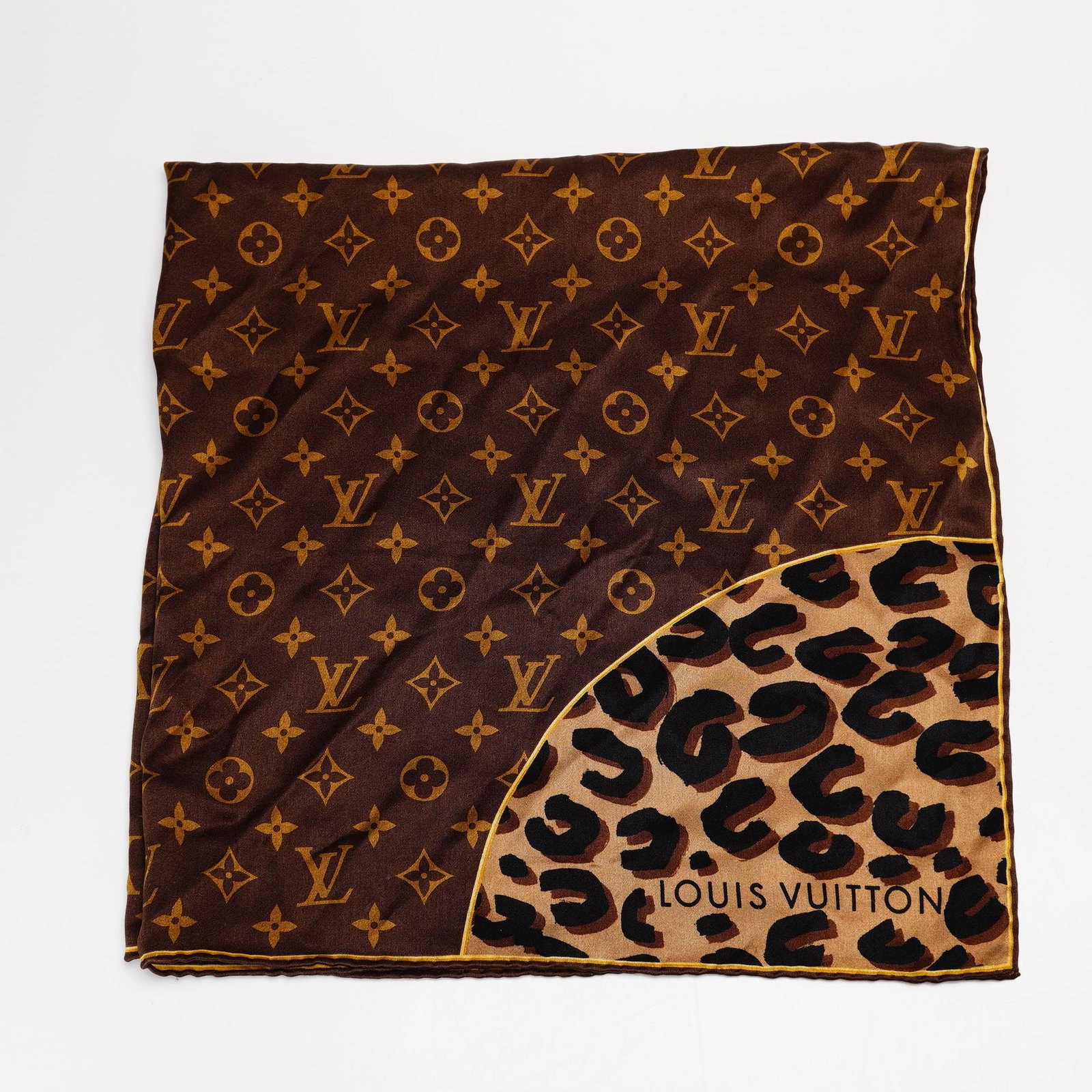 Louis Vuitton Silk Leopard Monogram Square Scarf: This Louis Vuitton silk leopard monogram square scarf is crafted from brown silk. The design features a dual-pattern composition with the signature Louis Vuitton monogram in tan across the primary bro