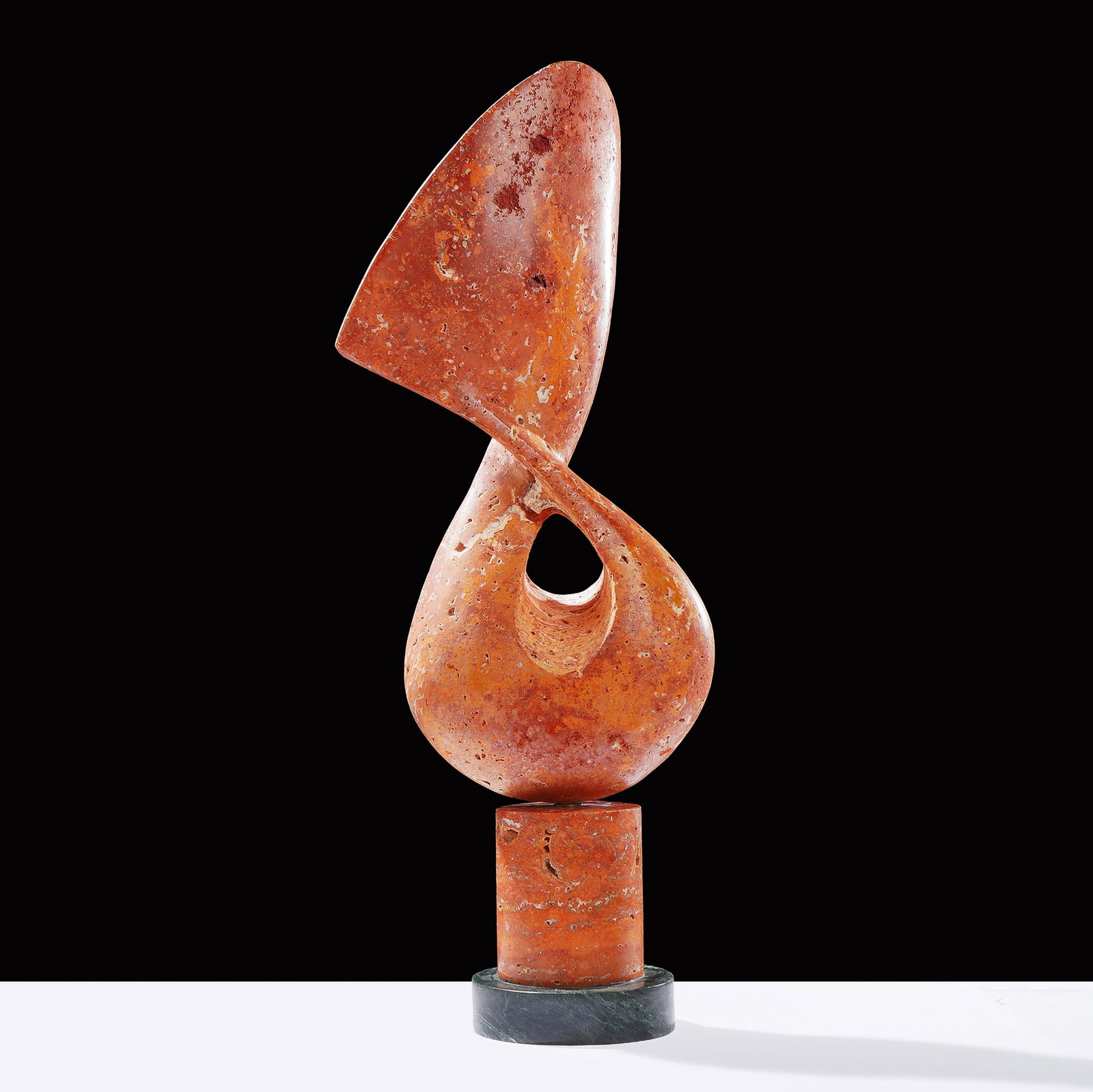 Arcadia Modernist Red Travertine Sculpture: Attributed to Liang and Eimil, this modernist abstract sculpture, titled Arcadia, is crafted from red and orange travertine marble. The piece features a biomorphic, vertical form that twists elegantly
