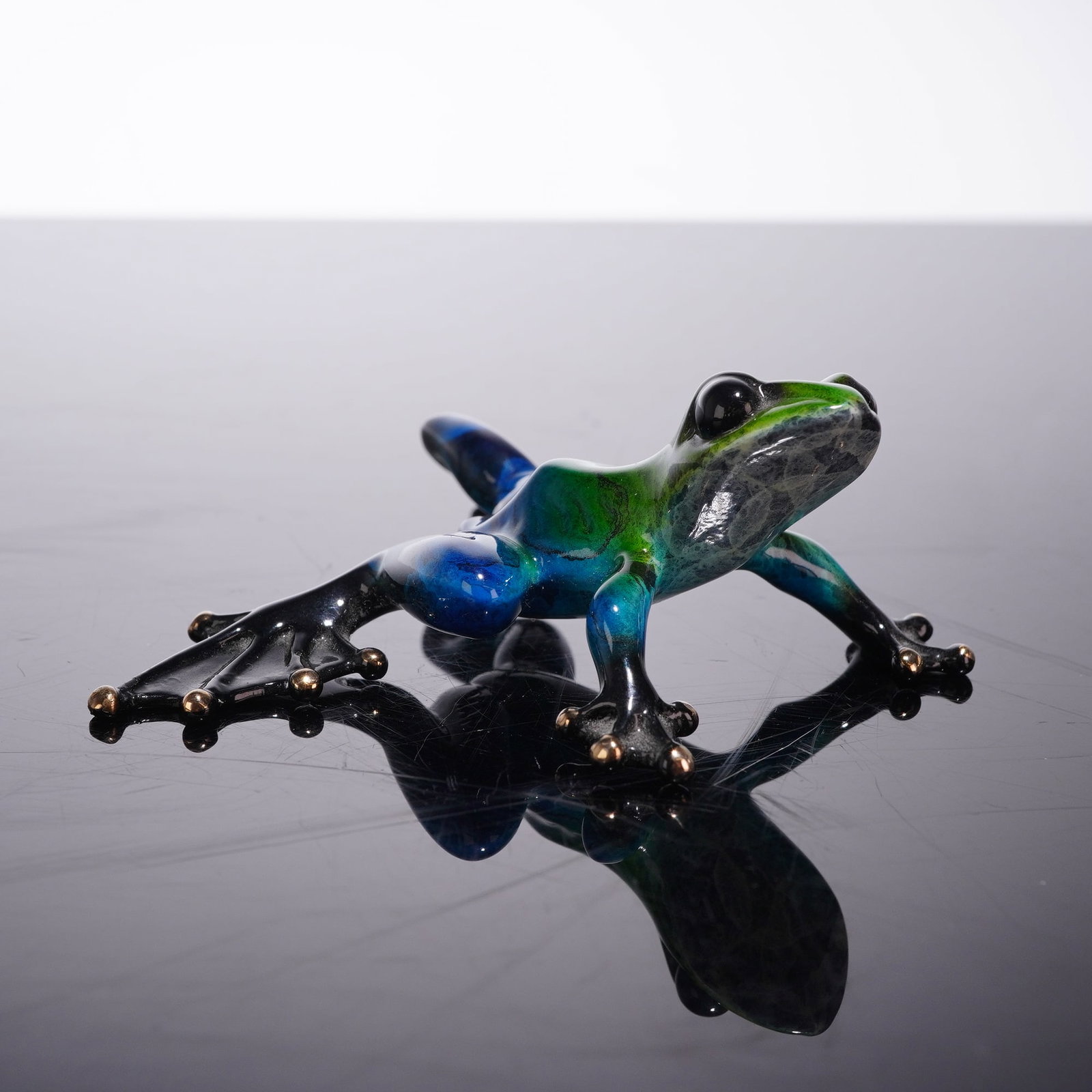 Tim Cotterill (British, b. 1946), Frogman Surf Polychrome Bronze Sculpture: Tim Cotterill (British, b. 1946), professionally known as Frogman, limited edition bronze sculpture titled Surf. This piece is part of the Frogman Miniature Collection and depicts a frog in a dynamic,