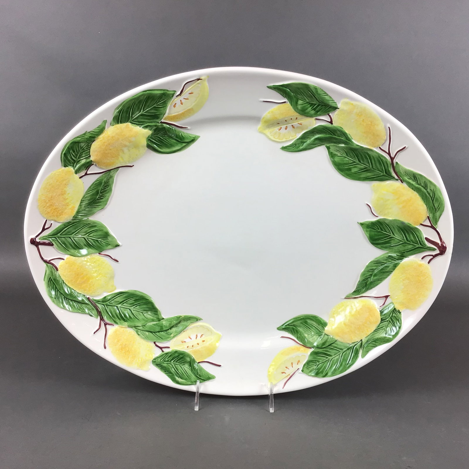 Williams-Sonoma Sorrento Lemon Italian Earthenware Oval Serving Platter: This large oval serving platter is part of the Sorrento pattern manufactured in Italy for the retailer Williams-Sonoma. The item is made of glazed earthenware and features a molded bas-relief border d
