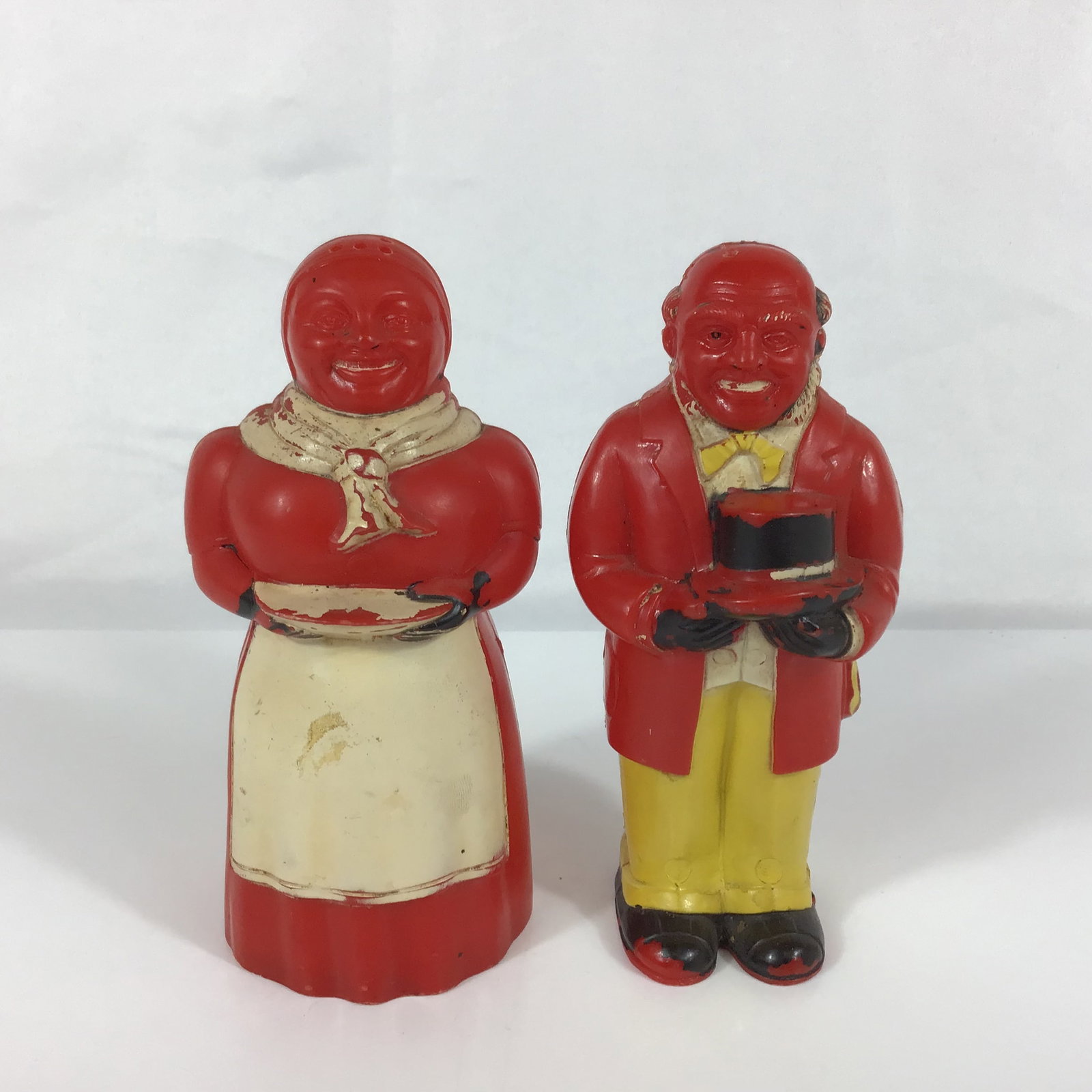 A Pair of F & F Die Works Aunt Jemima and Uncle Moses Plastic S&P Shakers: This pair of s & p shakers is a vintage 1950s Aunt Jemima and Uncle Moses set manufactured by F & F Die Works of Dayton, Ohio. The set features two figures constructed from red molded plastic with pai