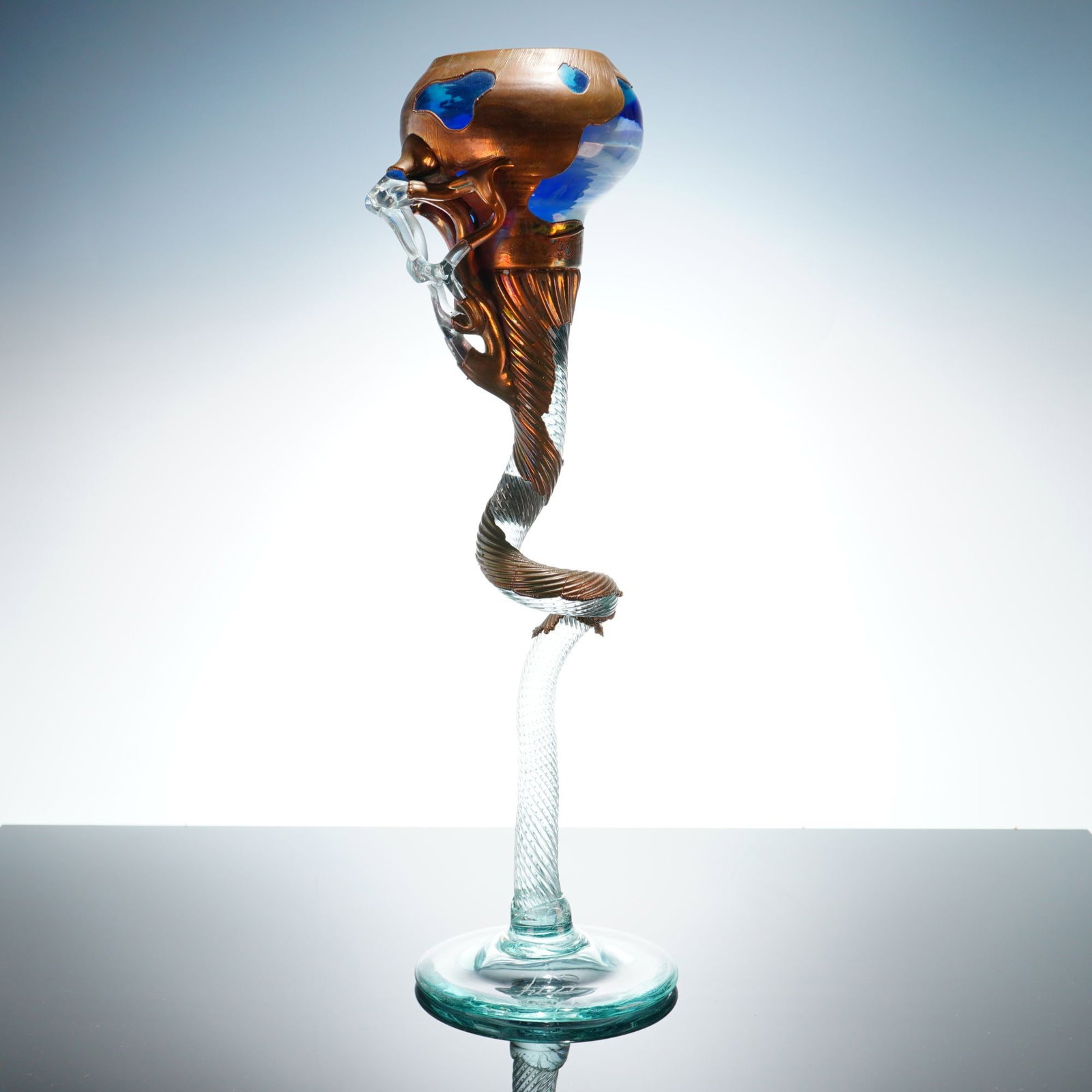 Filip Ravert Signed Art Glass and Metal Sculptural Vase: This contemporary mixed media sculpture is the work of artist Filip Ravert, as indicated by the etched signature on the base. The piece is designed as a decorative vase featuring a tall, slender, spir