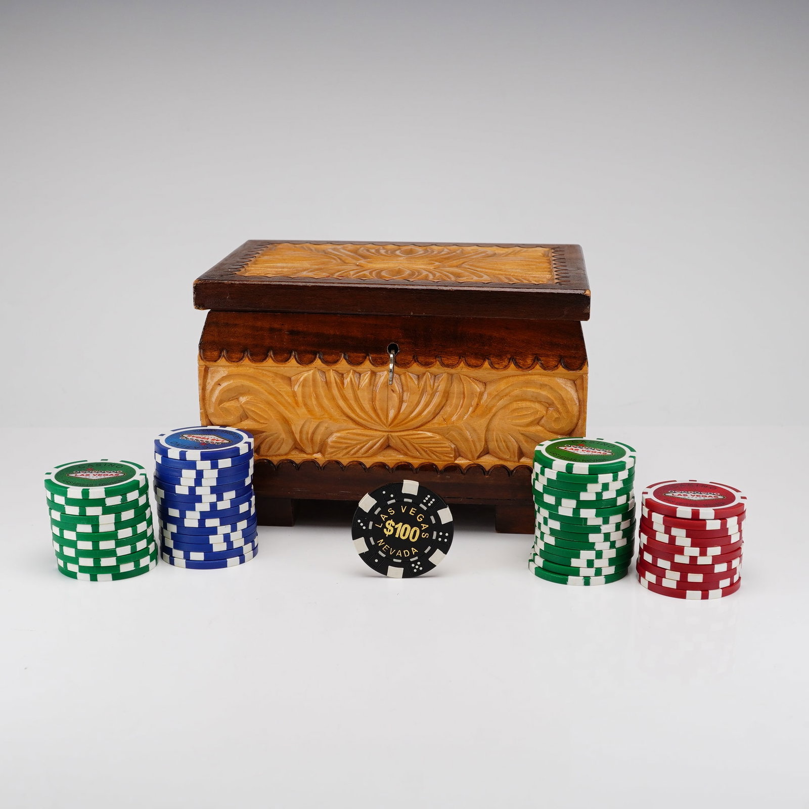 Las Vegas Souvenir Poker Set, Hand-Carved Wooden Chest, Late 20th Century: This Las Vegas souvenir poker set features a hand-carved wooden box with casino chips in them. The decorative storage chest is constructed from wood with a distinctive two-tone finish, featuring intri