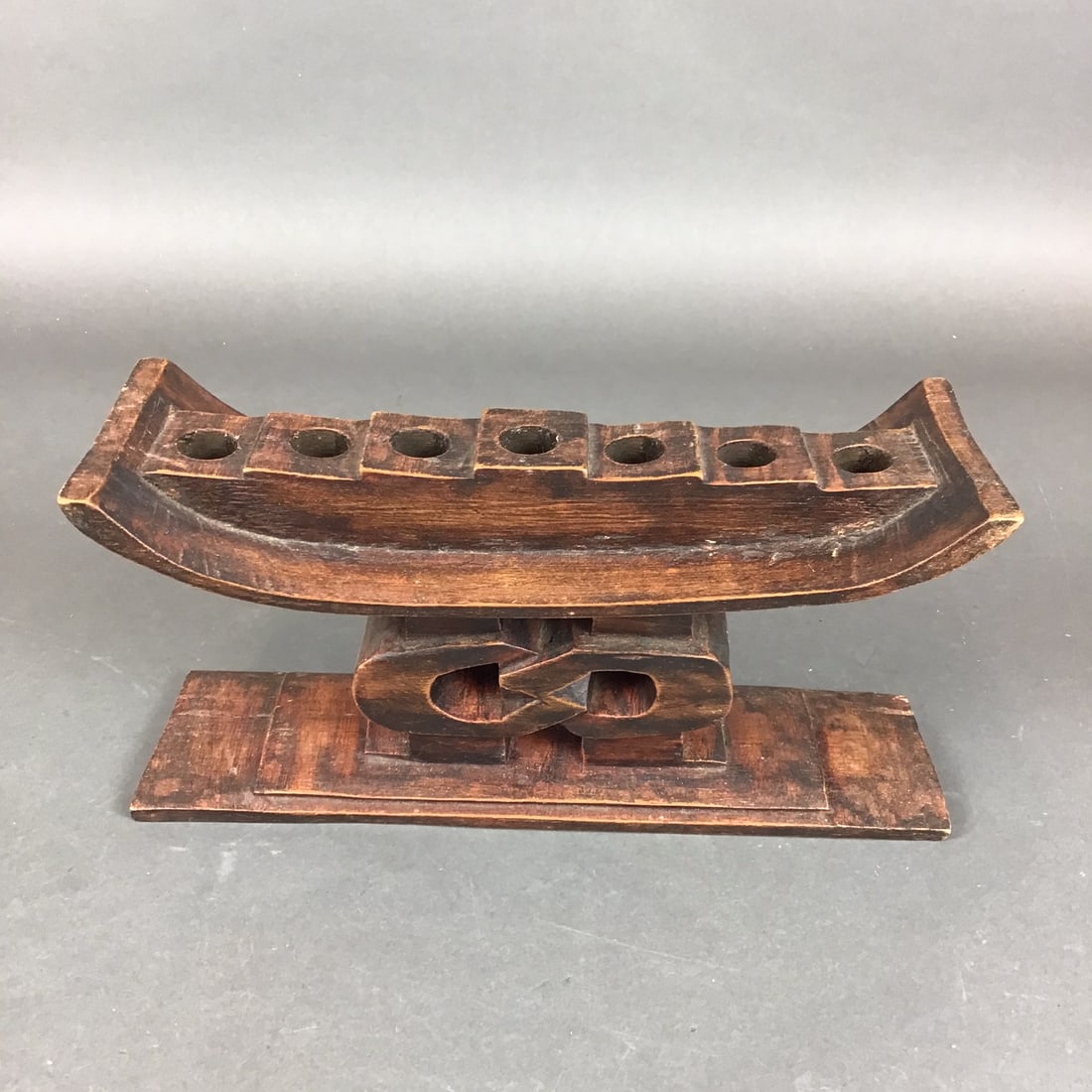 African Heritage Collection Hand Carved Wood Unity Kwanzaa Kinara: This hand-carved wooden kinara is part of the African Heritage Collection, identified as the Unity model. Produced in Ghana, the piece is constructed from wood with a dark brown stain and is designed 