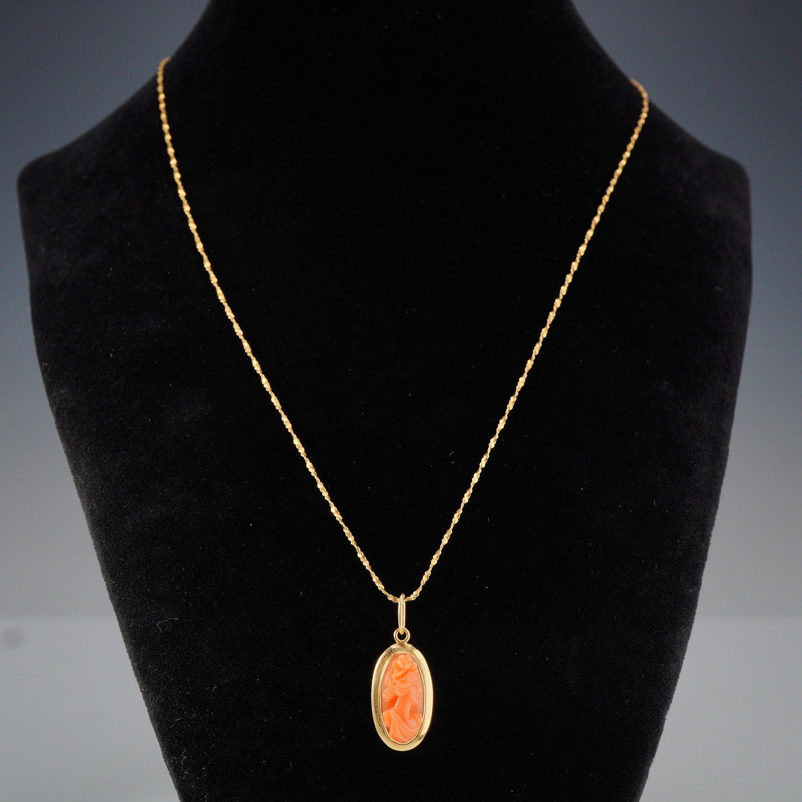 Vintage Italian 14K Gold Carved Pink Coral Cameo Necklace: Delicate 14K gold carved pink coral pendant depicting a lady on a 14K gold chain. Both pieces marked 14K, chain also marked Italy. Chain measures 20" full length, pendant is approx. 1"H x 0.5"L. Dimen