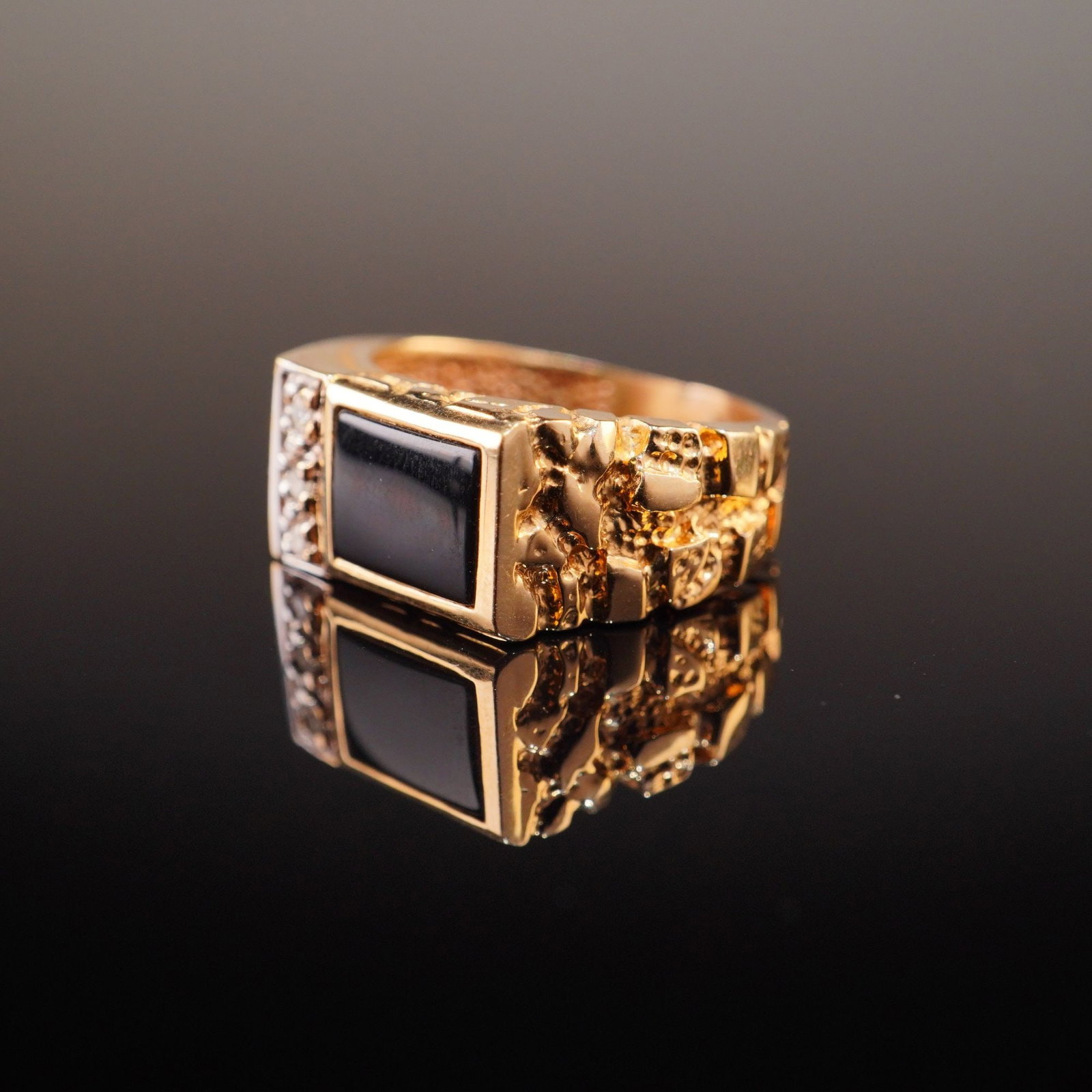 Men's 10 Karat Yellow Gold Black Onyx and Diamond Nugget Style Signet Ring: A men's signet-style fashion ring crafted in 10 karat yellow gold, typical of late 20th-century United States jewelry design. The center of the ring features a rectangular, flat-topped black onyx ston