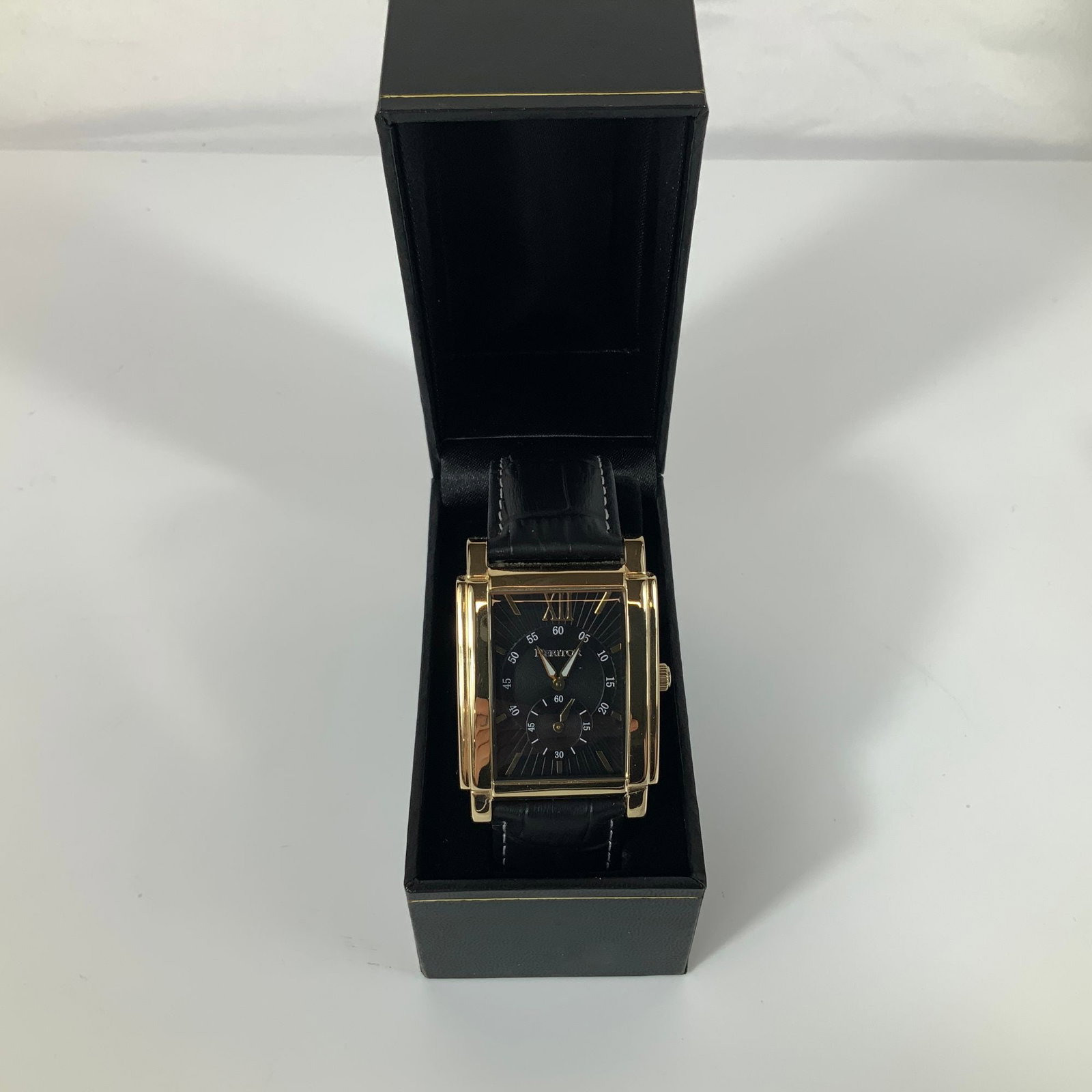 Heritor Frederick Automatic Men's Wristwatch: Heritor Frederick automatic wristwatch, reference HERHR6103. The timepiece features a gold-tone 316L stainless steel rectangular case and a black dial with a sunburst texture. The dial displays a gold