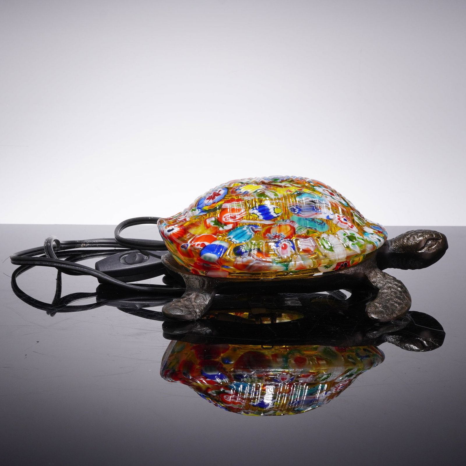 Rare Red/Blue Murano Millefiori Glass Turtle Table Lamp: This decorative turtle-form accent lamp features a Murano-style millefiori glass shell and a cast metal base. The shell is constructed using the millefiori technique, incorporating a vibrant assortmen