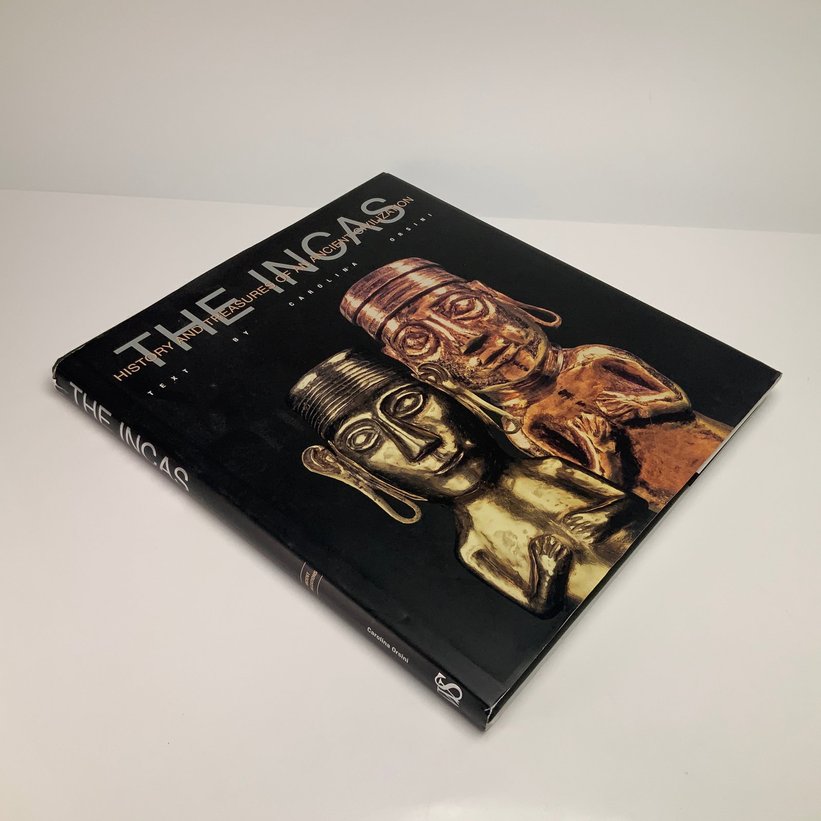 Hardcover Book, Orsini, Carolina. The Incas: History and Treasures of an Ancient Civilization. White: This quarto-sized hardcover volume, titled The Incas: History and Treasures of an Ancient Civilization, features text by Carolina Orsini. Published in 2008 by White Star Publishers (White Star S.p.A.,
