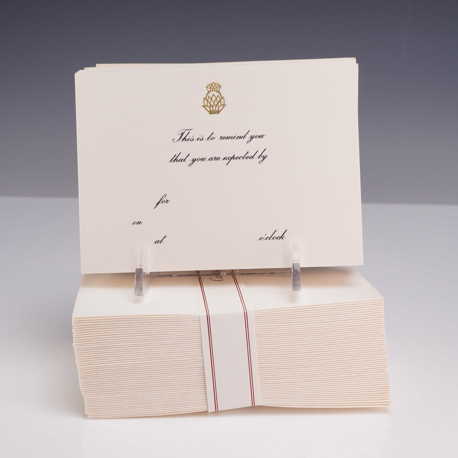 Collection of Pineapple Motif Reminder Cards with Cartier Envelopes and Presentation Box: This lot comprises a collection of reminder cards with envelopes, housed in their original red presentation box. The cream-colored cards are printed with a gold-embossed pineapple motif at the top cen