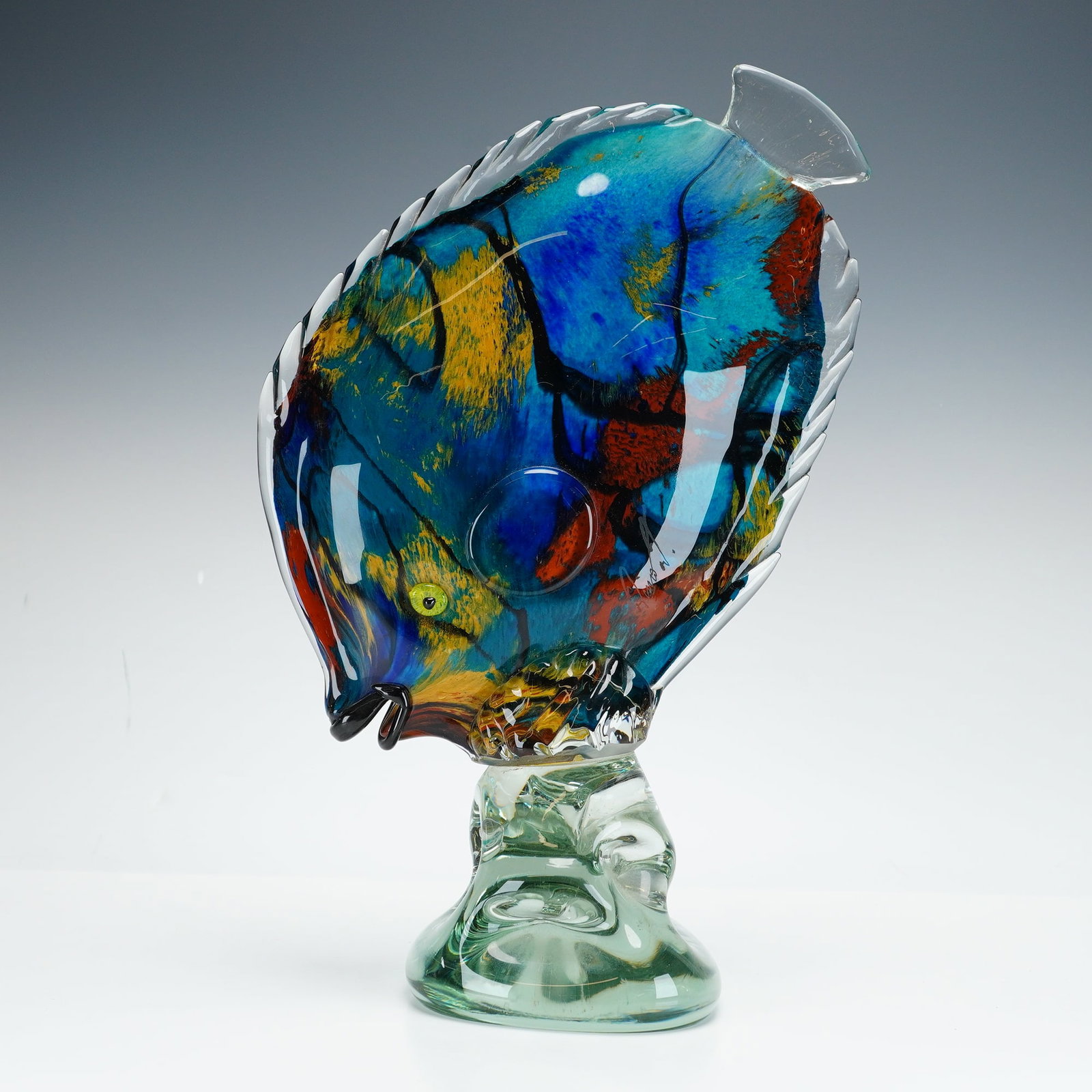 Sommerso Art Glass Fish Sculpture: This mid-century modern hand-blown piece utilizes the sommerso technique, featuring a vibrant internal core of cobalt blue, yellow, and orange-red pigments. The body is decorated with black linear pat