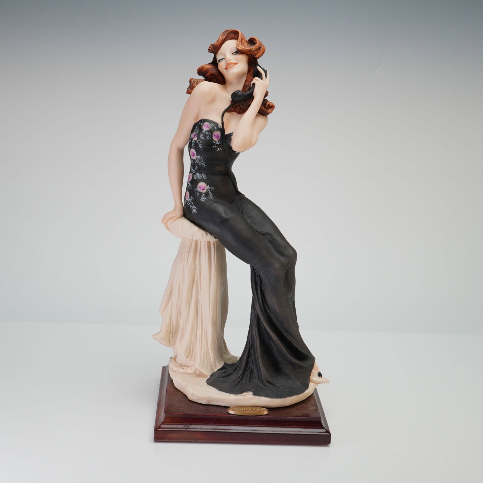 Giuseppe Armani Florence Sculpture The Caller 1279C: This hand-painted figurine, titled The Caller, is a creation of Giuseppe Armani for the Florence Sculture d'Arte studio in Italy. The piece depicts a stylized woman with voluminous auburn hair wearing