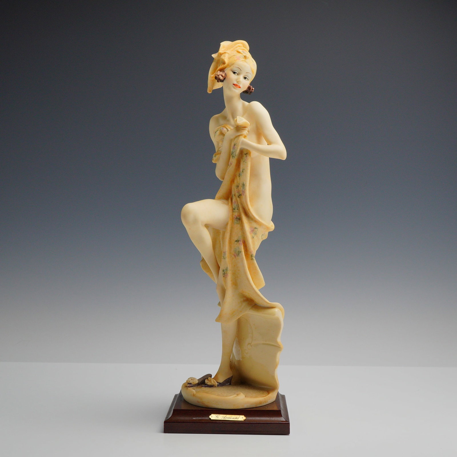 Giuseppe Armani Florence Sculture d'Arte Figurine Beauty at the Bath 0852C: This decorative figurine was produced by the Florence Sculture d'Arte studio and designed by Italian sculptor Giuseppe Armani. The piece depicts a stylized Art Deco-inspired female figure in a semi-nu