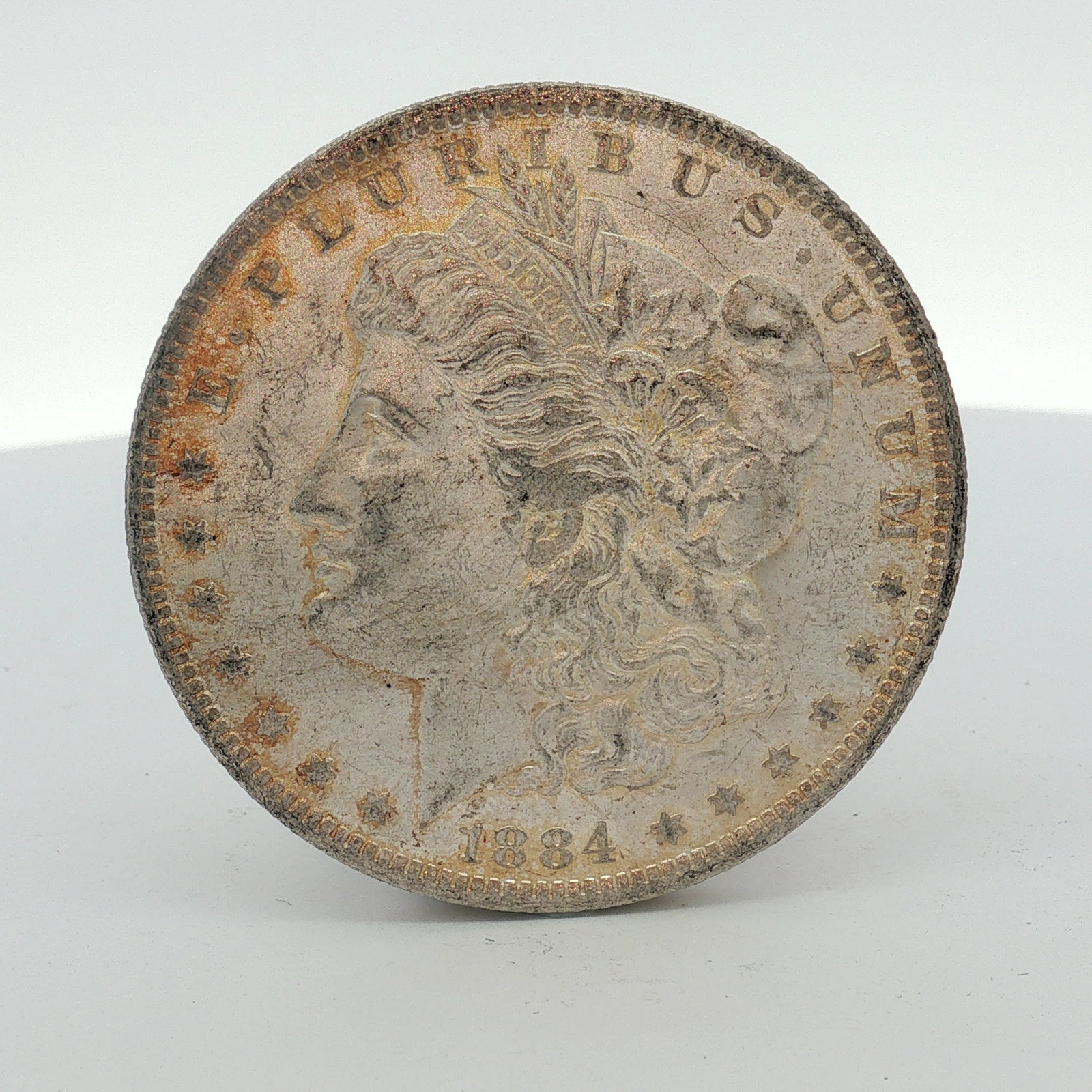 1884-O US Morgan Silver Dollar Coin Circulated: This US Morgan silver dollar was struck at the New Orleans Mint in 1884. The coin features the Morgan dollar Liberty Head obverse and Eagle with arrows and olive branch on the reverse designs. An O mi