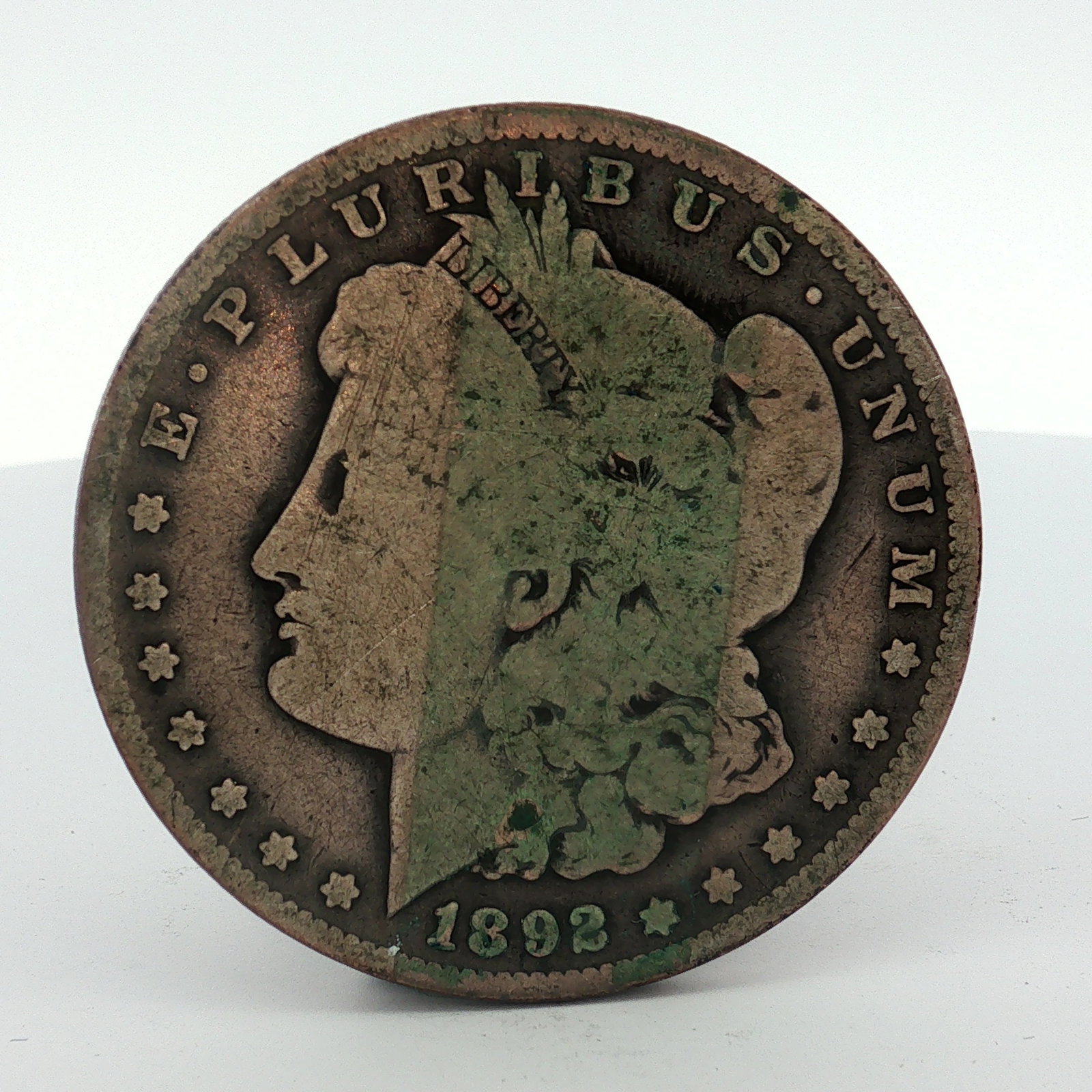 1892-O US Morgan Silver Dollar Coin Circulated: This US 1892-O Morgan Silver Dollar was struck at the New Orleans Mint. The coin is composed of .900 silver and .100 copper. It features the Liberty head obverse and the heraldic eagle reverse. The O 