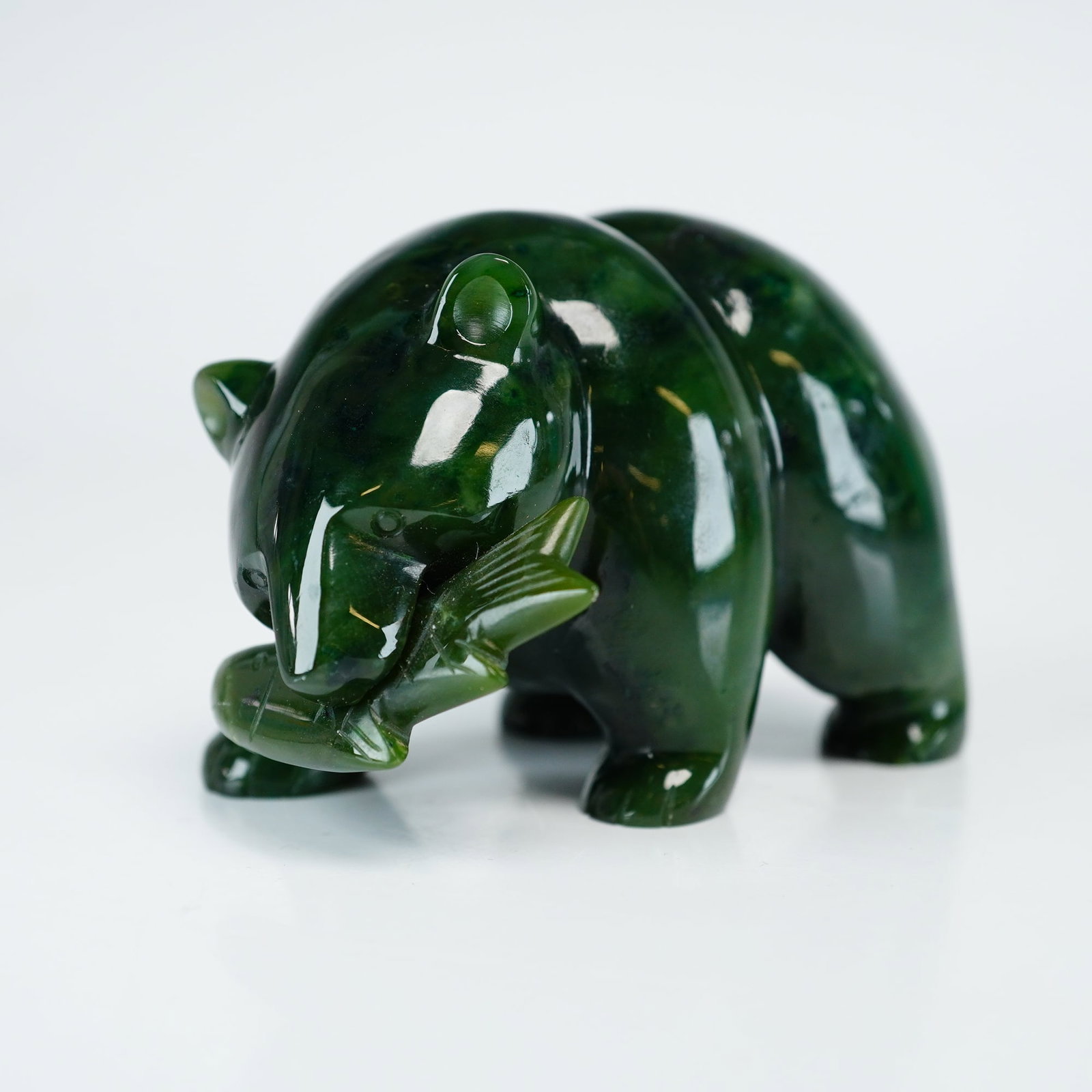 Jade Figurine, Grizzly Bear with Salmon: Hand Carved Jade Grizzly Bear, designed with caught salmon gripped in his jaws. Unmarked. Dimensions: 3.00"L x 2.00"W x 2.00"H Weight: 9.00oz