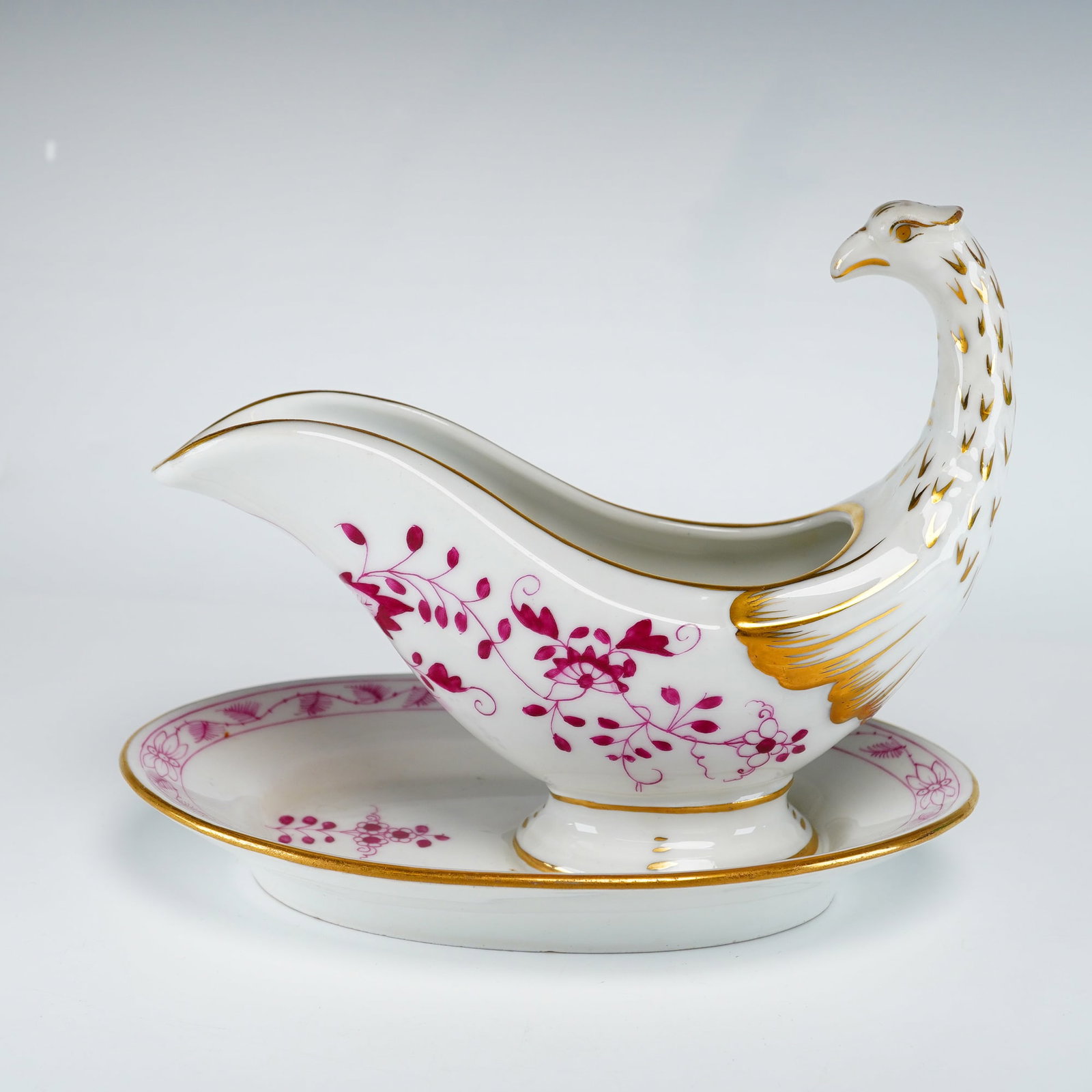 C. Tielsch & Co. (TPM) Indian Purple Porcelain Figural Bird Gravy Boat with Attached Underplate: The vessel is modeled with a handle in the form of an elongated bird neck and head, with the body of the boat featuring molded wing details. The boat is permanently attached to an integral oval underp