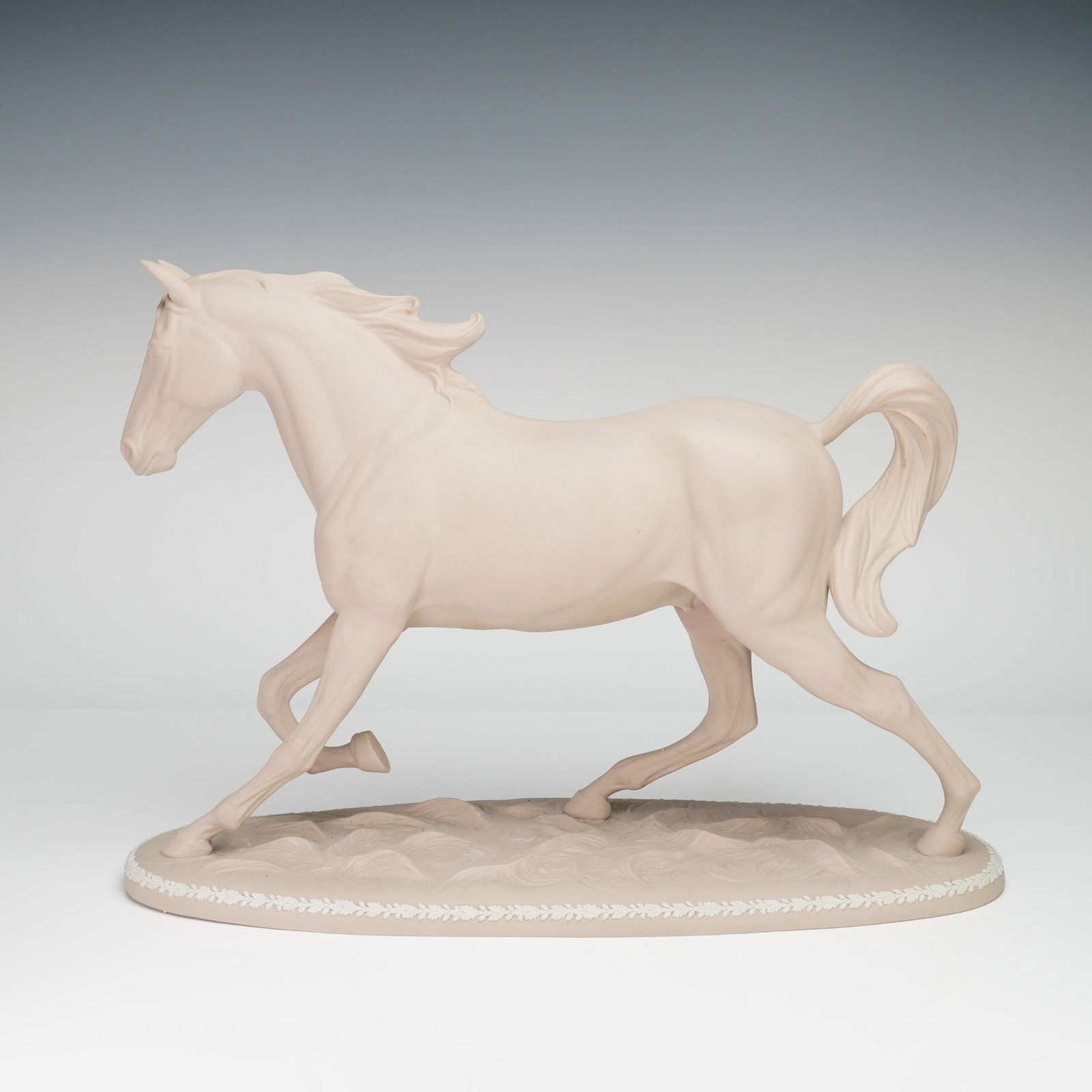 Wedgwood Etruria Hall Horse Jasperware Sculpture: A Wedgwood jasperware sculpture of a horse, known as the Etruria Hall Horse model. The piece is rendered in a pale cream-colored unglazed vitreous stoneware. The horse is modeled in a trotting pose wi