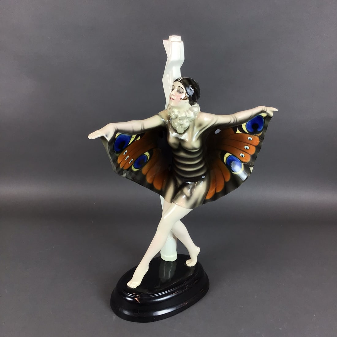 Goldscheider Austria Art Deco Lamp Base Figure of Lady with Butterfly Wing Dress by Josef Lorenzl: This Art Deco ceramic figure was produced by the Goldscheider factory in Vienna, Austria. The piece was designed by sculptor Josef Lorenzl and depicts a dancer in a stylized pose with her arms outstre
