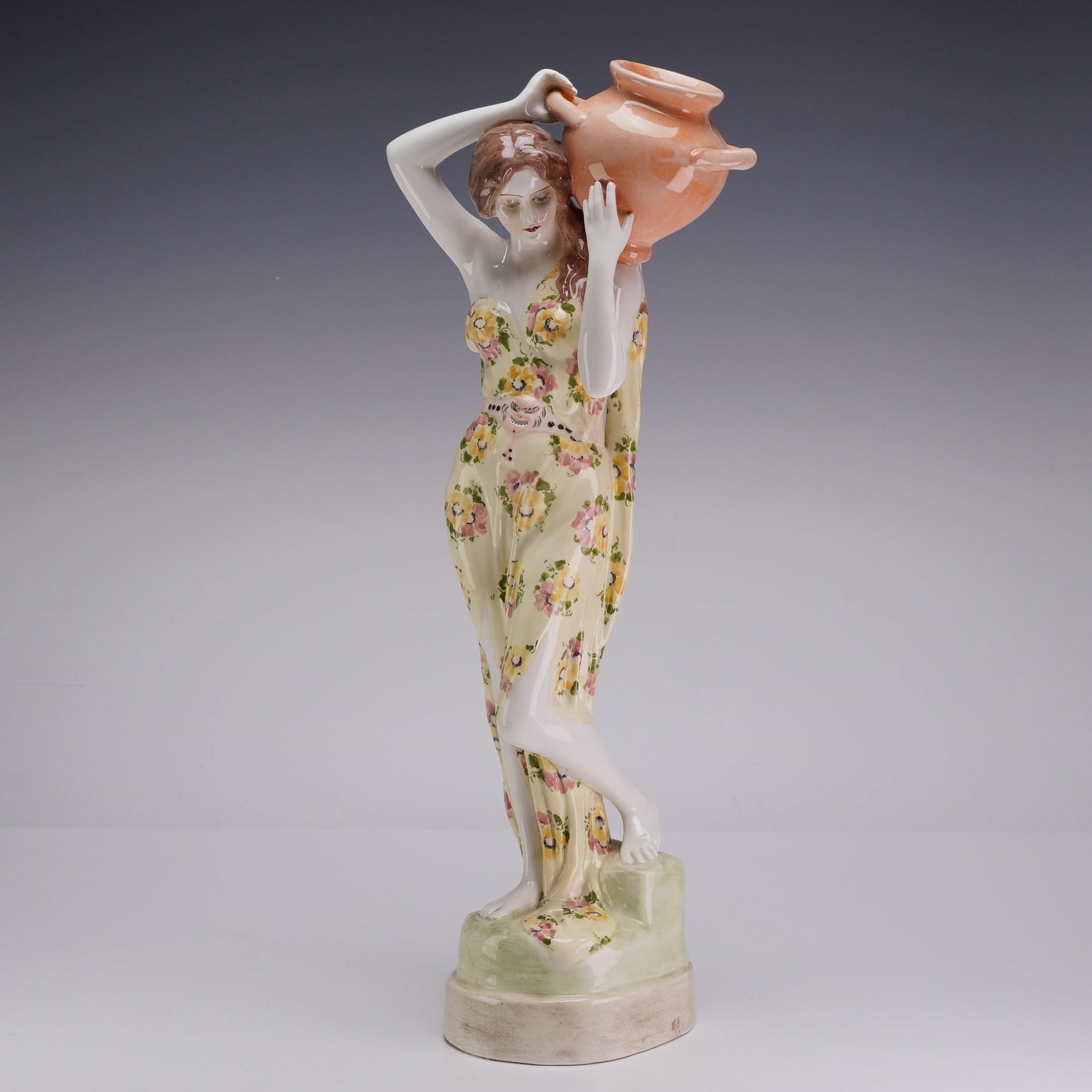 Goldscheider Austrian Ceramic Water Carrier Figurine Signed Grohs: This polychrome glazed ceramic figurine was produced by the Goldscheider factory in Vienna, Austria. The model is designed by artist Ferdinand Grohs, whose signature is incised on the side of the base