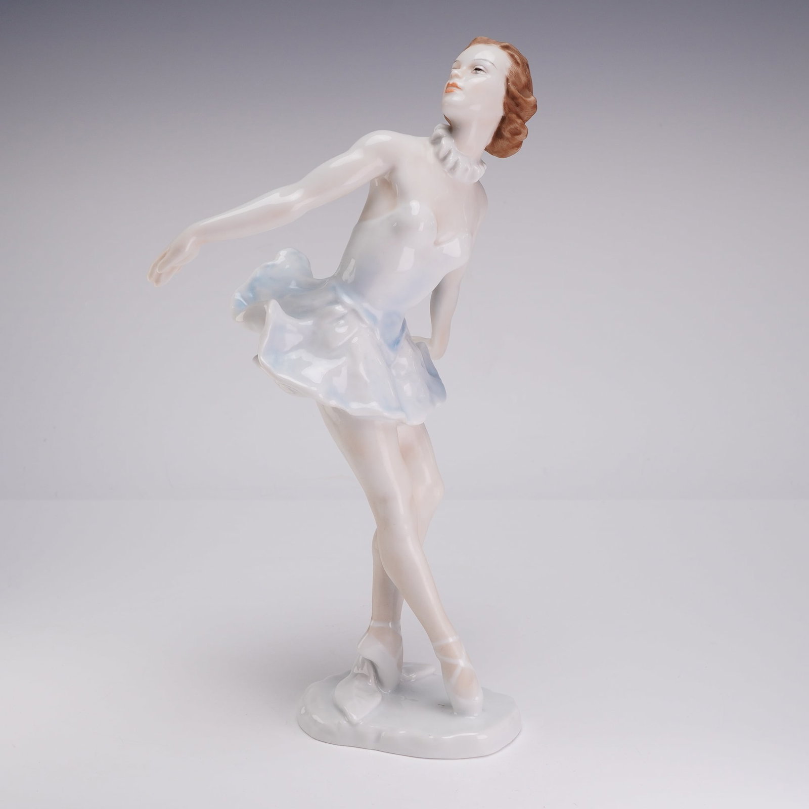 Rosenthal Porcelain Ballerina Figurine, Marianne Simson: Rosenthal porcelain figurine of the dancer Marianne Simson designed by Lore Friedrich-Gronau. The glazed porcelain figure is depicted on pointe wearing a white bodice and a ruffled tutu with light blu
