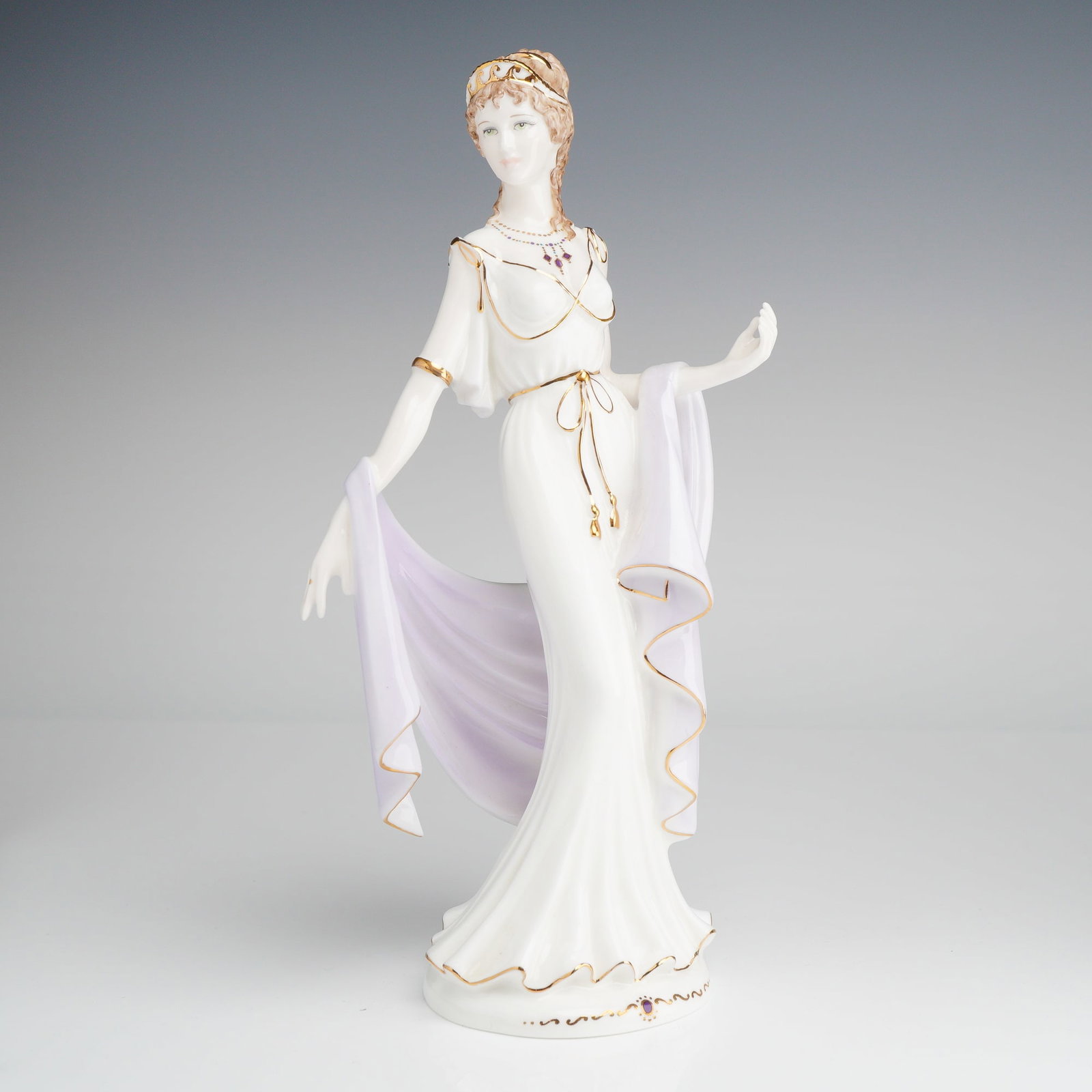 Coalport Bone China Figurine, Helen of Troy: Presented is a glazed bone china piece depicting Helen of Troy from Greek mythology. She is dressed in a white dress with a lavender shawl, accented with 22 carat gold detailing. The underside is mark
