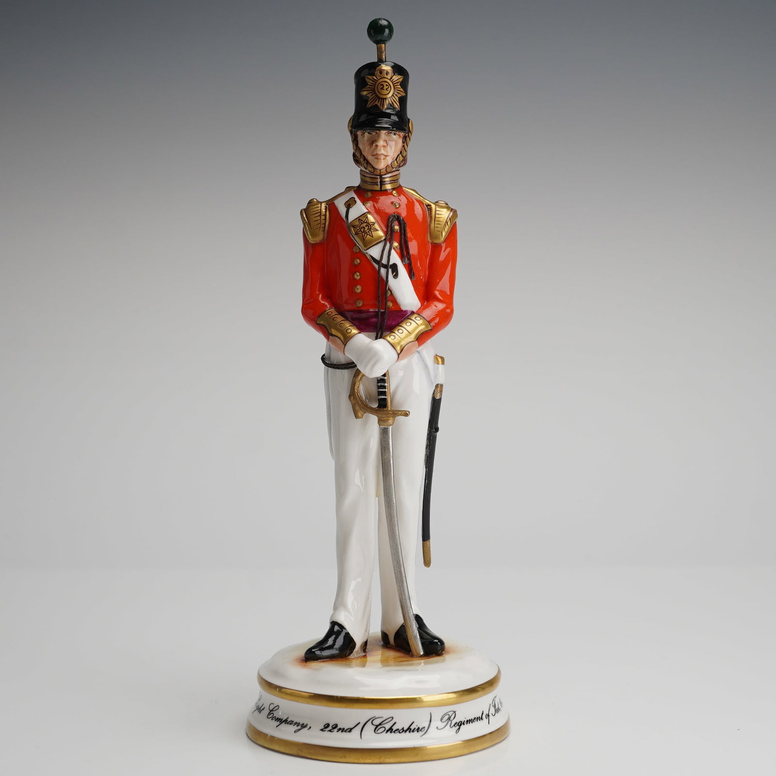 Michael Sutty Figurine, 22nd (Cheshire) Regiment of Foot Officer: A limited edition hand-painted porcelain figurine attributed to Michael Sutty, depicting an officer of the Light Company, 22nd (Cheshire) Regiment of Foot, circa 1843. The figure is modeled in a stand