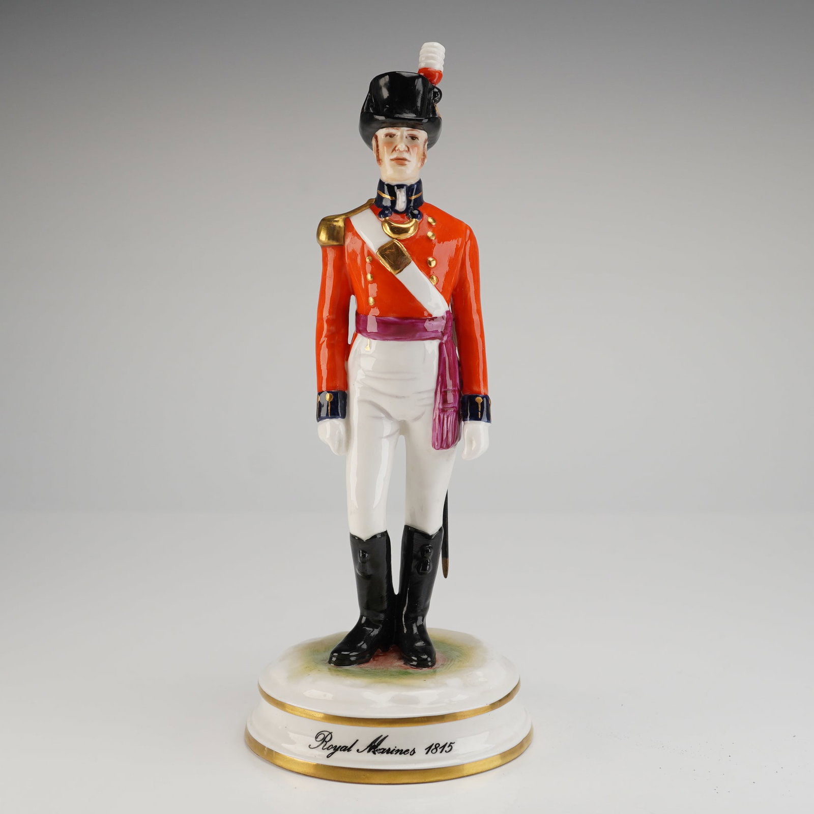 Michael Sutty Porcelain Figure Royal Marines 1845: A single limited edition porcelain figurine by Michael Sutty, depicting a Royal Marine Officer dated 1845. The figure is modelled and hand-painted in polychrome enamels, showing the officer in a red c