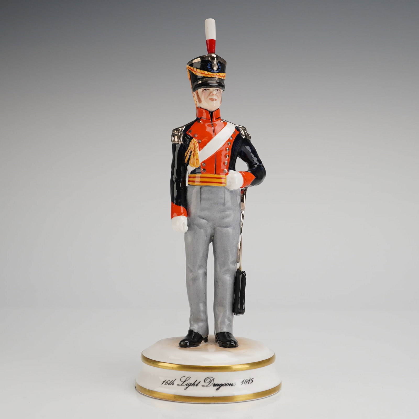 Michael Sutty Porcelain Figurine 16th Light Dragoons 1815: A limited edition hand-painted porcelain military figurine produced by the Michael Sutty Porcelain Manufactory. The figure depicts a soldier of the 16th Light Dragoons, modeled in the historical unifo