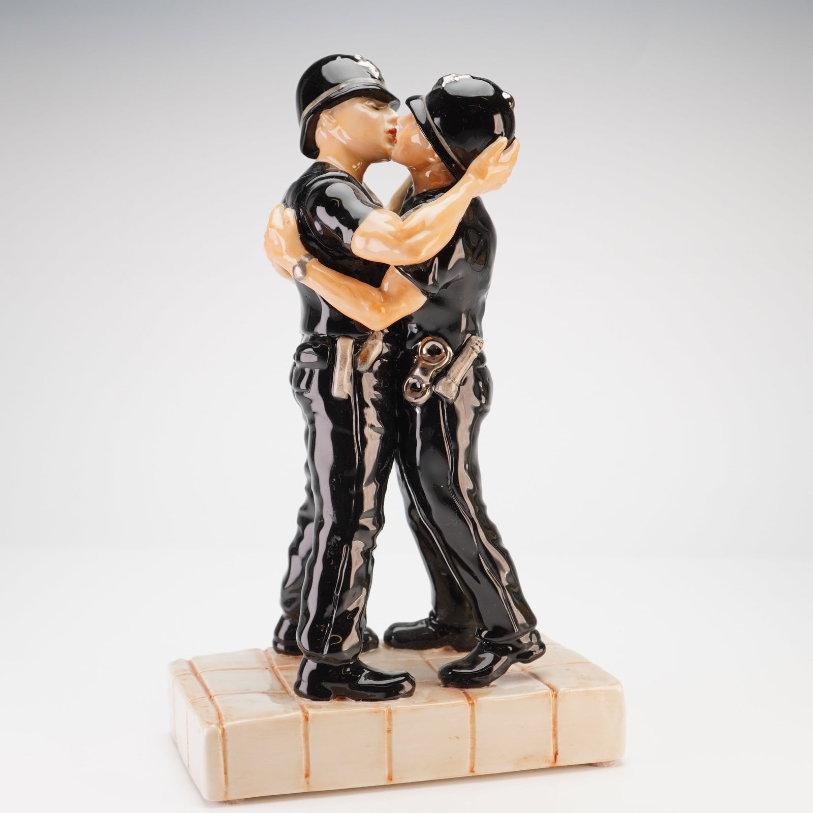 Kevin Francis Ceramics Banksy Kissing Coppers Limited Edition Figurine: This ceramic figurine is produced by Kevin Francis Ceramics as part of the Street Art series, titled Banksy's Kissing Coppers. It is a three-dimensional rendering of the street artist Banksy's famous 