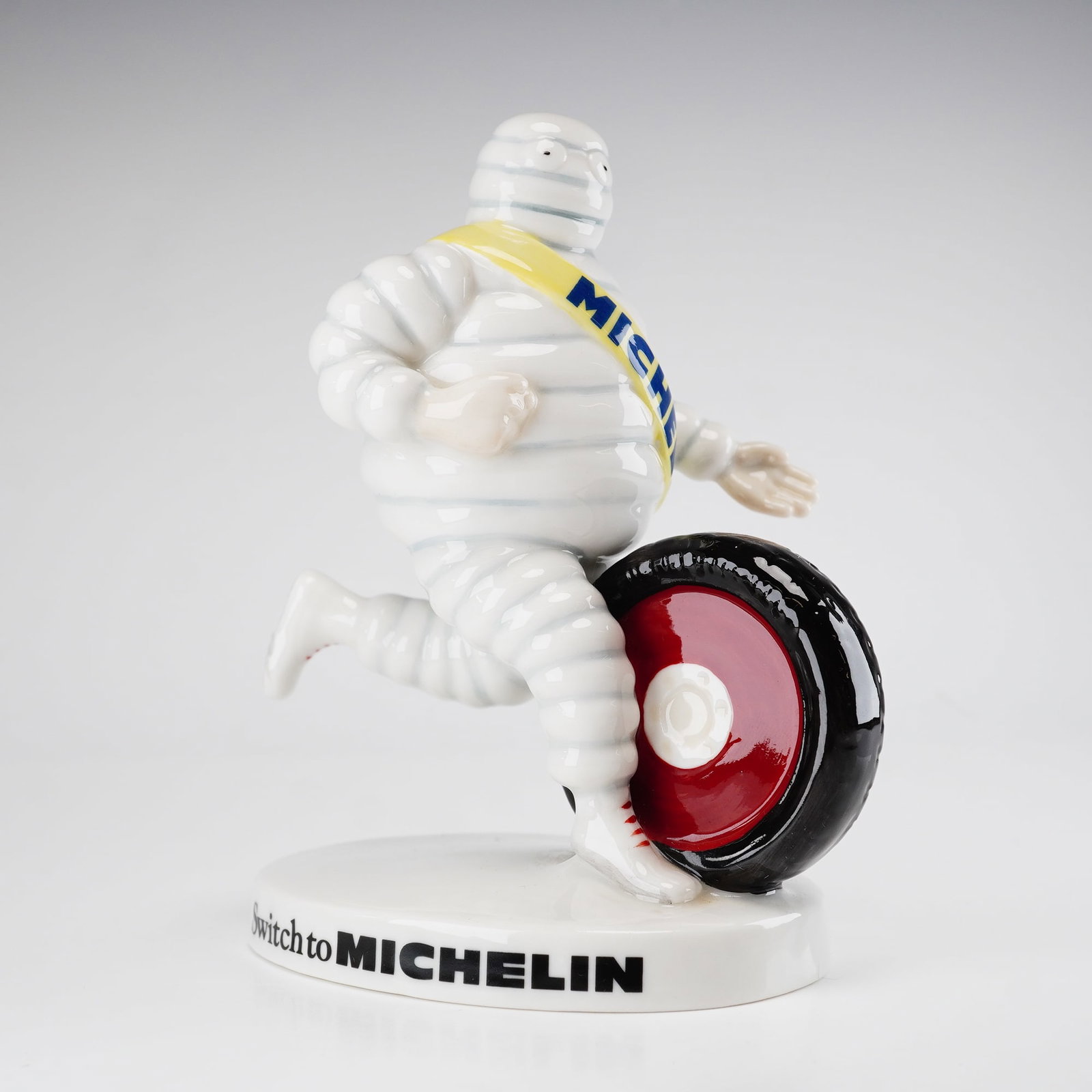 Royal Doulton Bibendum Michelin Man Limited Edition Figurine MCL 9: This porcelain figurine, model MCL 9, is a limited-edition advertising collectible produced by Royal Doulton in 2003. The piece features the Michelin brand mascot, Bibendum, in a dynamic running pose 
