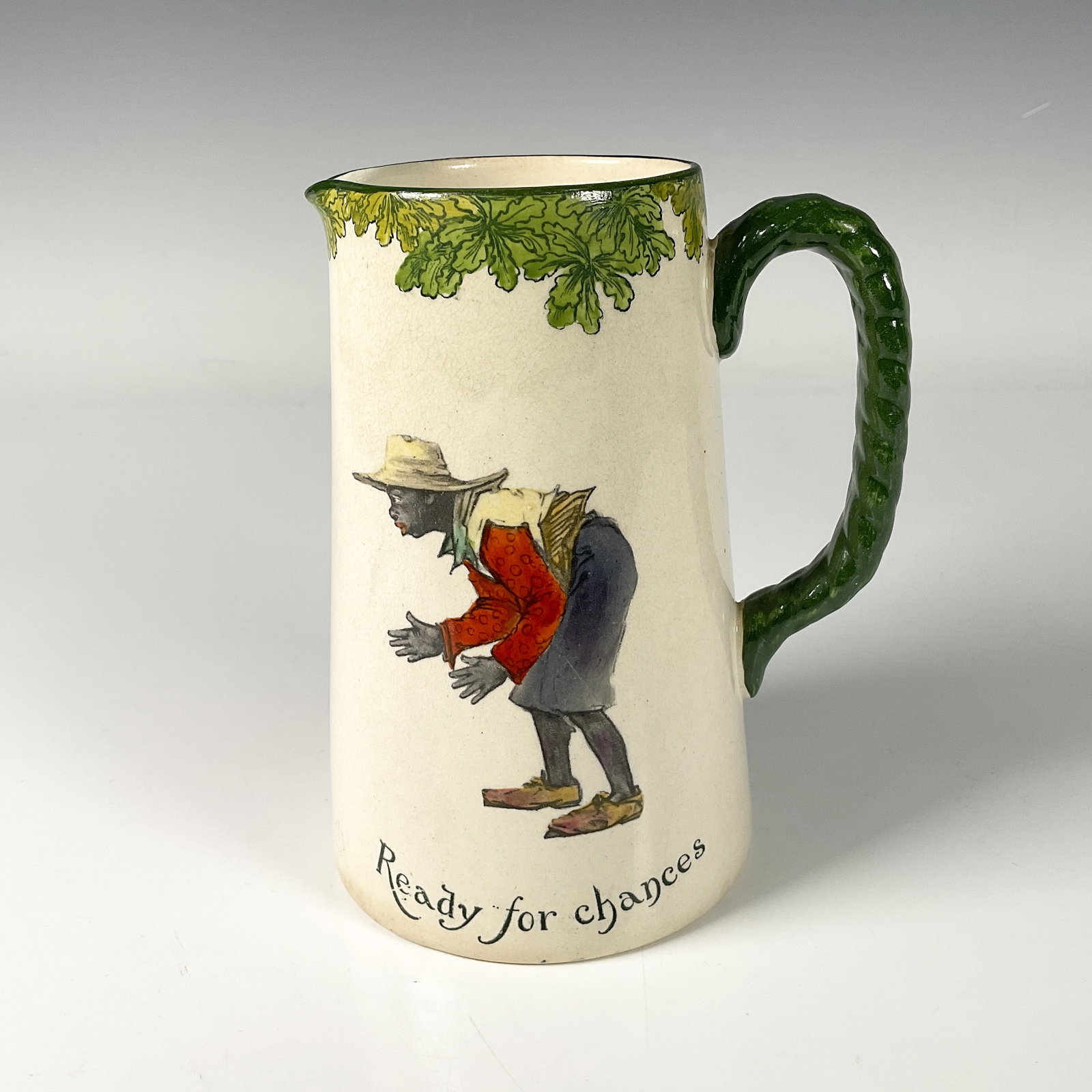 Royal Doulton Porcelain Jug, All Black Team Cricketer: Collectible jug adorned with green color accents on the edge and handle from the All Black Team series, featuring an African boy titled Ready for chances. Royal Doulton backstamp. Dimensions: 5"L x 3.