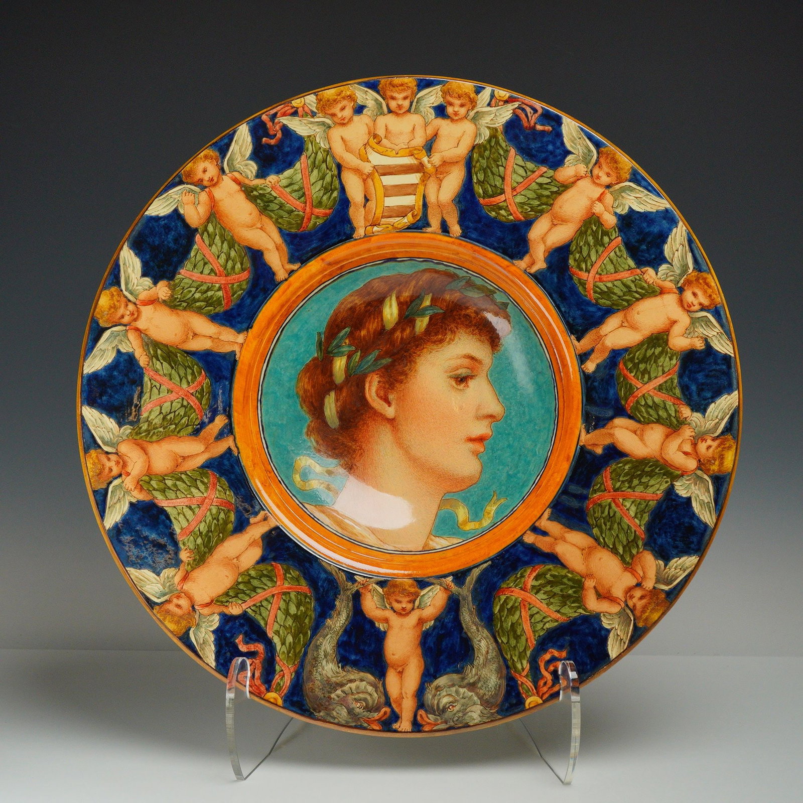 Minton by Ellen Welby (1851-1936) Earthenware Aesthetic Movement Portrait Bowl: Hand-painted by the artist Ellen Welby, the central well features a profile portrait of a woman wearing a laurel wreath, set against a turquoise blue ground. The wide cobalt blue rim is intricately de