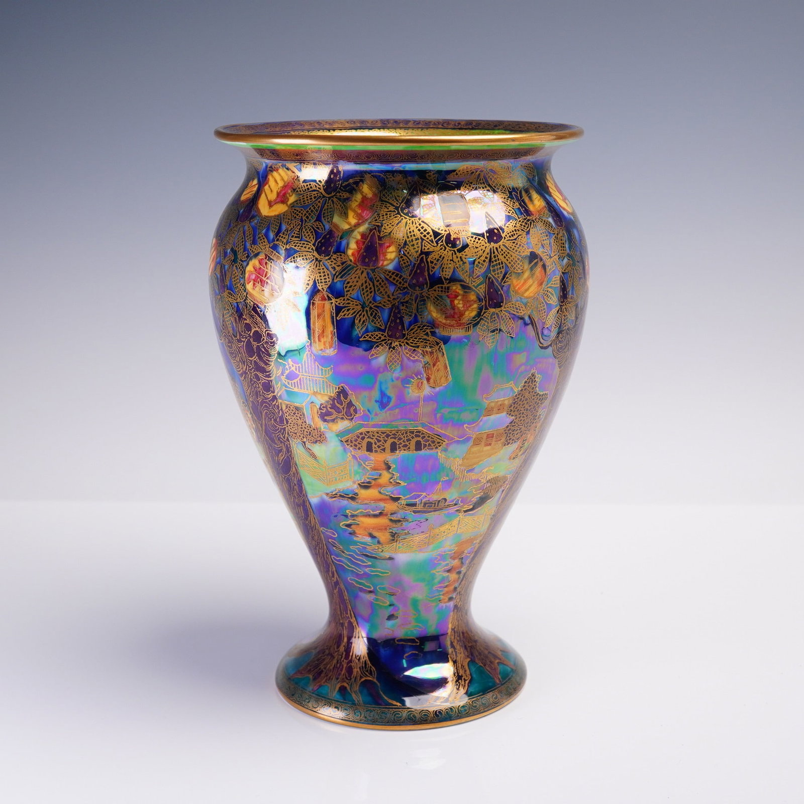 Wedgwood Moonlight Fairyland Lustre Vase, Willow Z5462: Decorated in the rare Moonlight Fairyland Lustre palette, this Wedgwood porcelain vase features the intricate 'Willow' pattern on a deep cobalt ground enriched with peacock-green and mother-of-pearl l