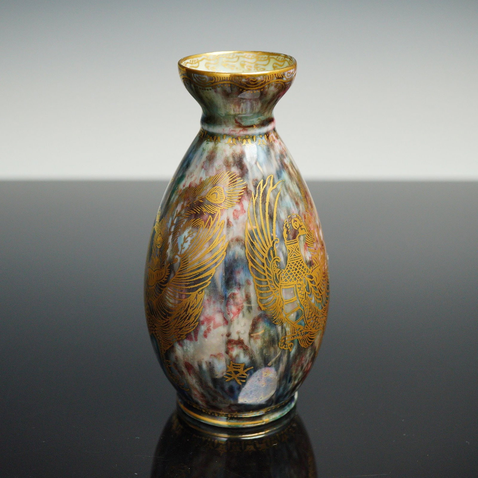 Wedgwood Fairyland Lustre Pheasant Vase, Z4831: Designed by Daisy Makeig-Jones. Small vase featuring a green lustre with multicolored mottling, decorated with gilt images of pheasants. The top rim features the Aquatic Bead border. The interior has 