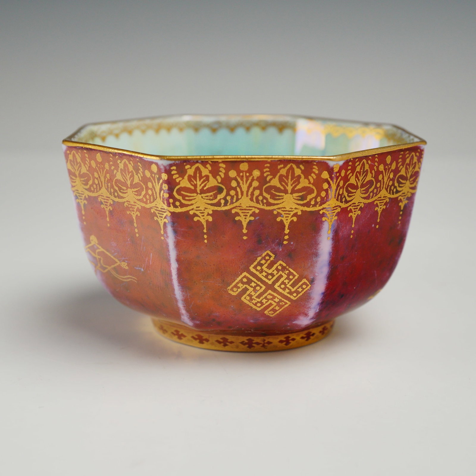 Wedgwood Fairyland Lustre Red Octagonal Small Bowl: This Wedgwood Fairyland Lustre red octagonal small bowl was designed by Daisy Makeig-Jones during the 1920s. The vessel is crafted from fine bone china and features a mottled claret red luster glaze o