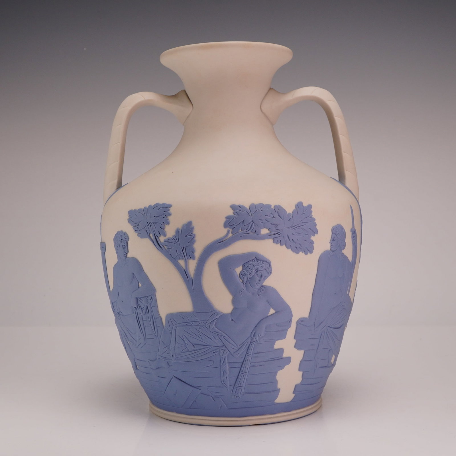 Wedgwood Jasperware Portland Vase: This Wedgwood Jasperware Portland Vase is a reproduction of the celebrated Roman cameo glass original. The vessel is crafted from white jasperware with a matte finish and features sprigged bas-relief 