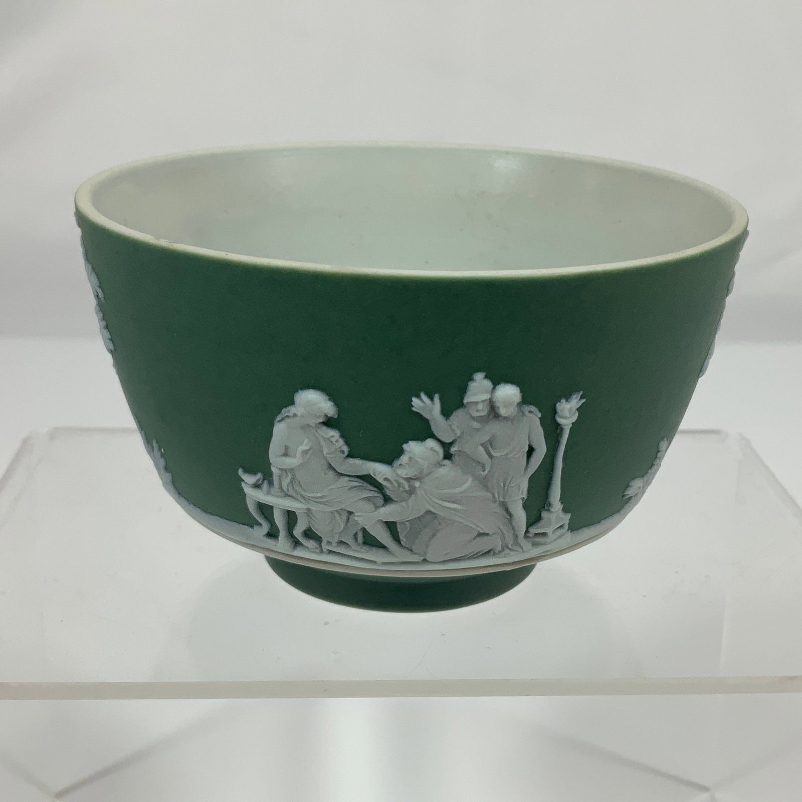 Wedgwood Sage Green Jasperware Sacrifice Pattern Finger Bowl: A Wedgwood sage green jasperware finger bowl, featuring the Sacrifice pattern. This piece is constructed from unglazed stoneware with a matte jasper finish on the exterior and a white glazed interior.