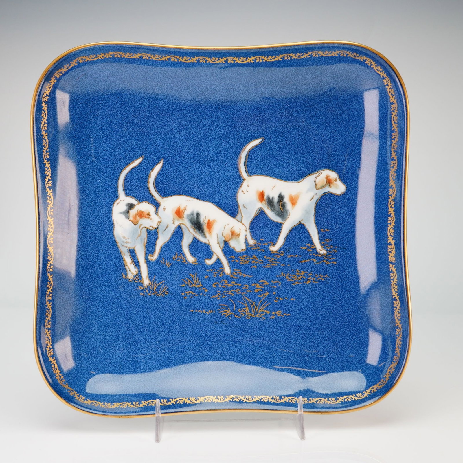 Wedgwood Powder Blue Bone China Square Dish with Hunting Hounds from the Rubin Collection: This square fine bone china dish was manufactured by Wedgwood in England. The form features a shallow well with a lobed rim and rounded corners. The interior is decorated with a speckled cobalt powder