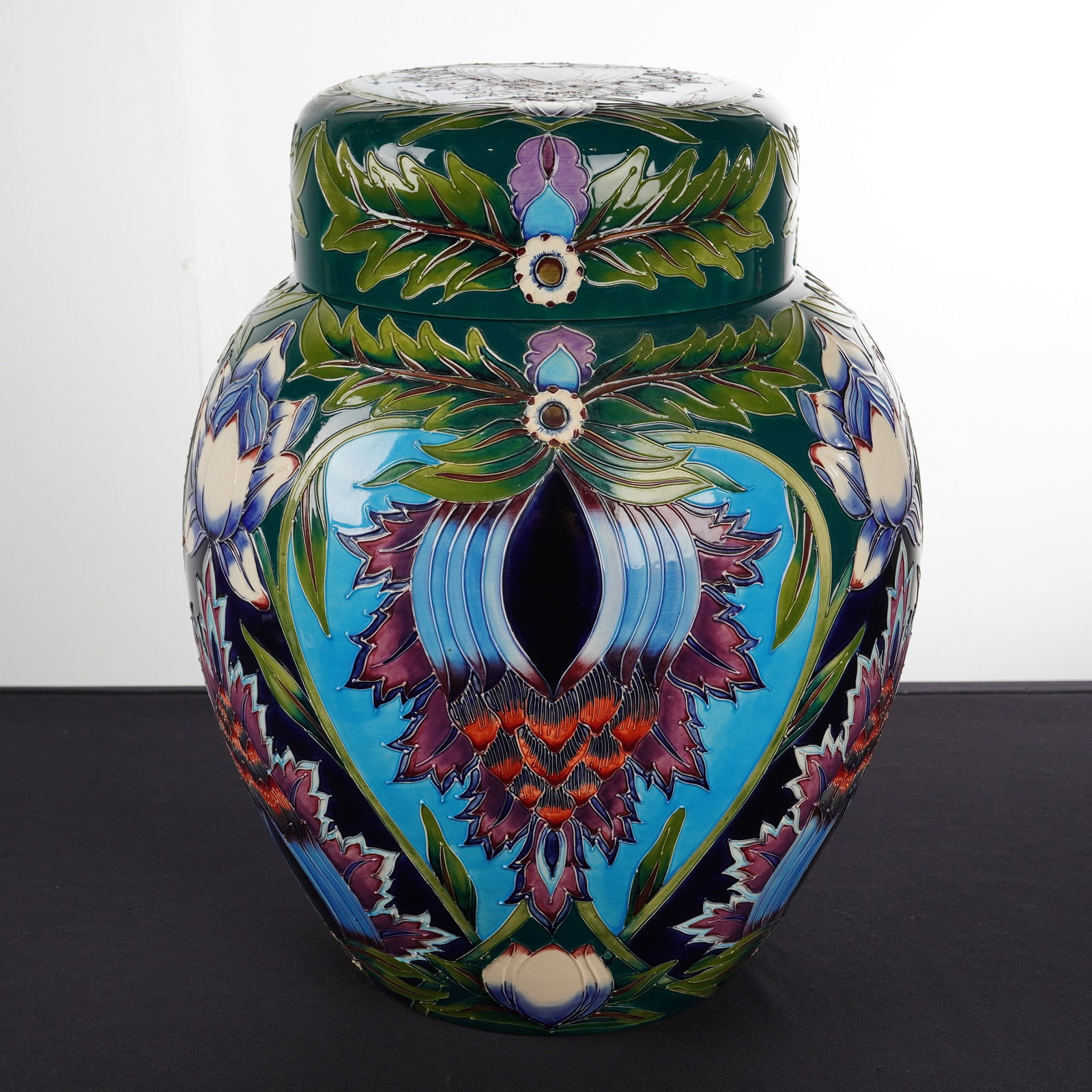 Moorcroft Pottery by Shirley Hayes Large Lidded Ginger Jar, Saadian: A large glazed lidded decorative jar, tubelined and painted in bright tones of green, aquamarine, purple, mauve, oatmeal, and blue, featuring stylized floral and foliage motifs. The underside of the j