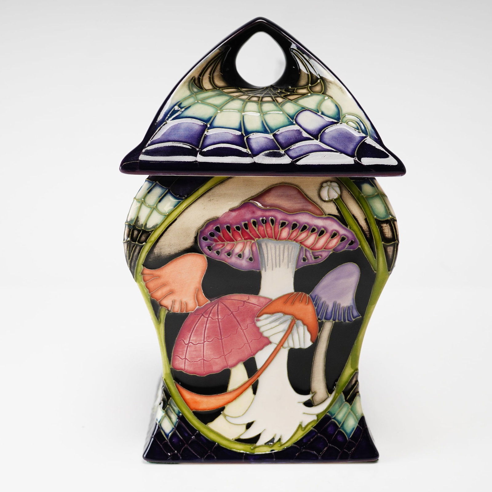 Vicky Lovatt for Moorcroft Pottery Lidded Box, Twilight Bonnets: This lot features a contemporary Moorcroft art pottery lidded jar in the Twilight Bonnets pattern, designed by Vicky Lovatt. The piece is crafted from glazed earthenware and features a square-section 