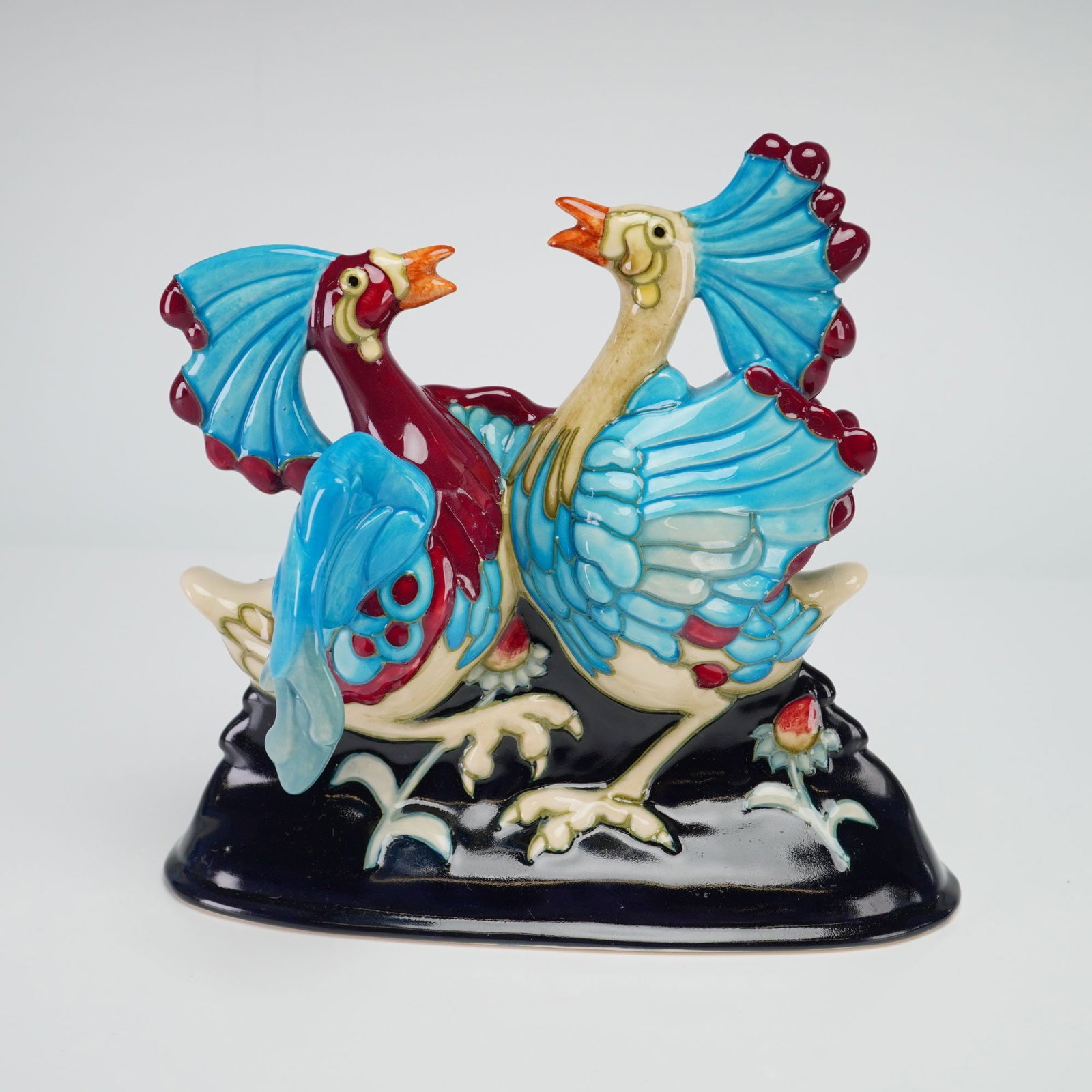 Moorcroft Pottery by Kerry Goodwin Figurine, Can Can Birds: A 2006 limited edition 18 out 75, depicts two exotic birds characterized by their large fan-shaped crests and vibrant plumage in shades of blue, burgundy, and cream. The birds are posed facing each ot