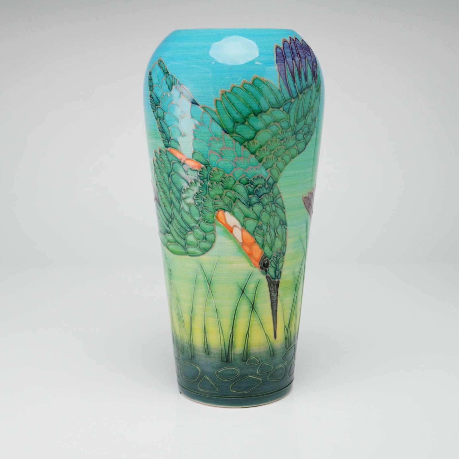 Dennis China Works Pottery by Sally Tuffin Kingfisher Vase: The vase is decorated using the tube-lining technique to create raised outlines, which are then finished with hand-painted glazes. The design depicts a kingfisher in a diving pose over stylized green 