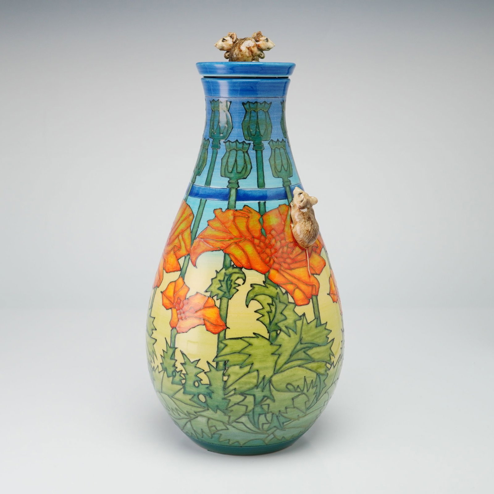 Dennis China Works Pottery by Sally Tuffin, Large Poppies and Mice Lidded Vase: The limited edition piece features a bulbous, teardrop-shaped body with a tapered neck and a matching lid. The exterior is hand-decorated with a tube-lined and hand-painted botanical motif, featuring 