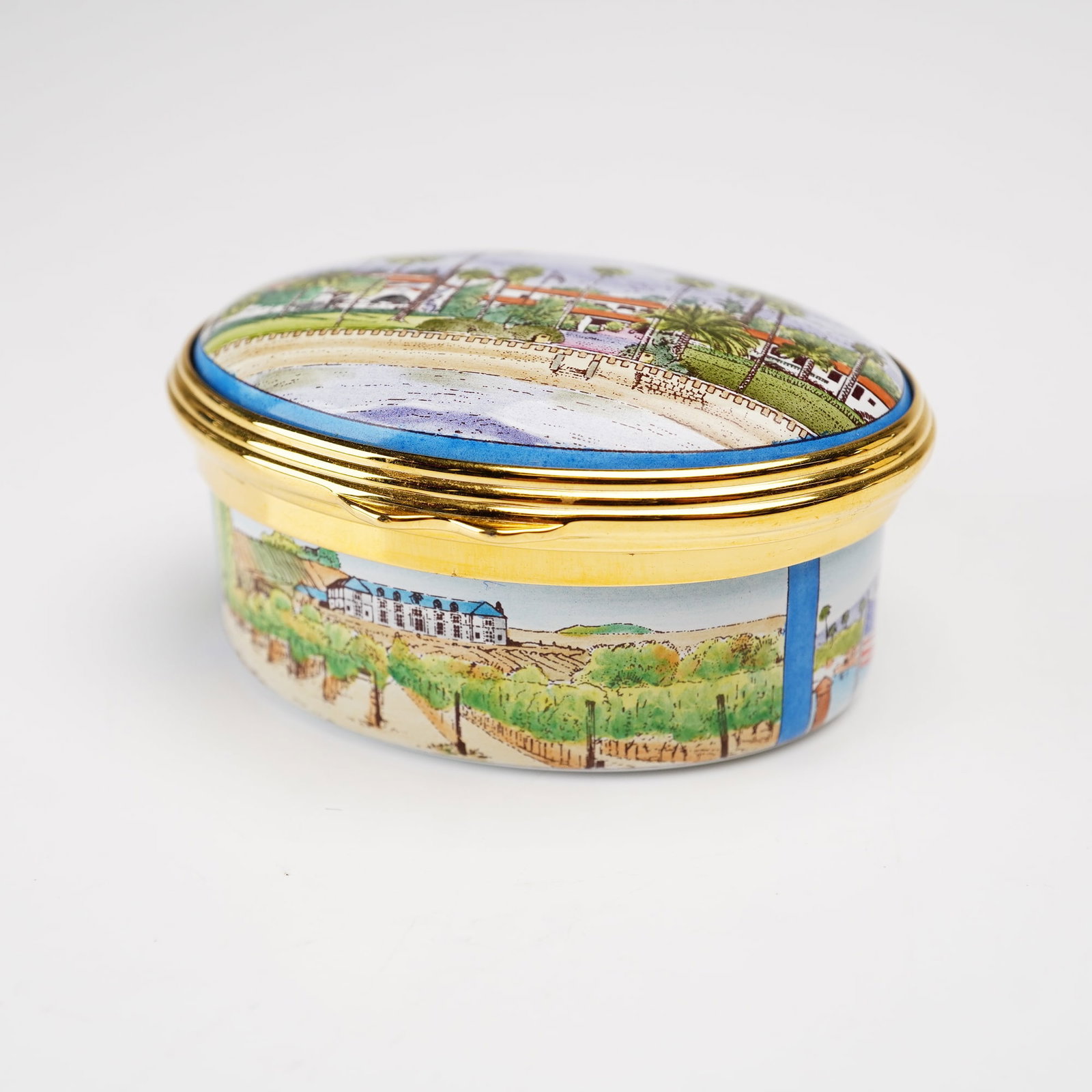 Halcyon Days Enamels for St. Jame's Place Limited Edition Treasure Box, Santa Barbara 2007: This commemorative treasure box is manufactured by Halcyon Days Enamels in England. The piece is an oval hinged box made of enamel on copper with gilded metal mounts. The domed lid depicts a landscape